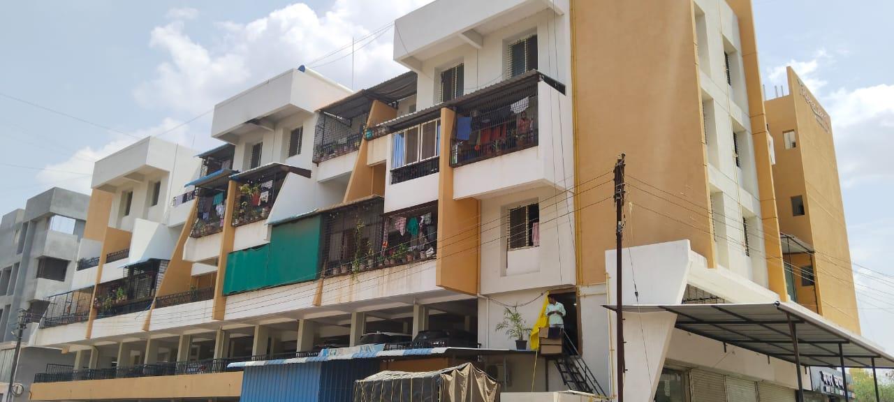 A closer view of the residential building which has an interesting modular color panel design. The building appears to use contrasting rectangular sections of ochre/yellow and white that create a visual rhythm across the facade. (Source: CKA Archives)