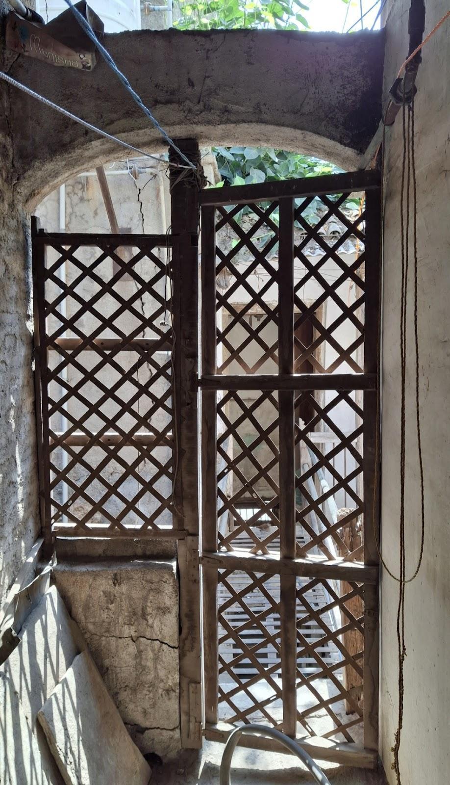 This door with a distinctive design is situated at the ancillary space of the house. (Source: CKA Archives)