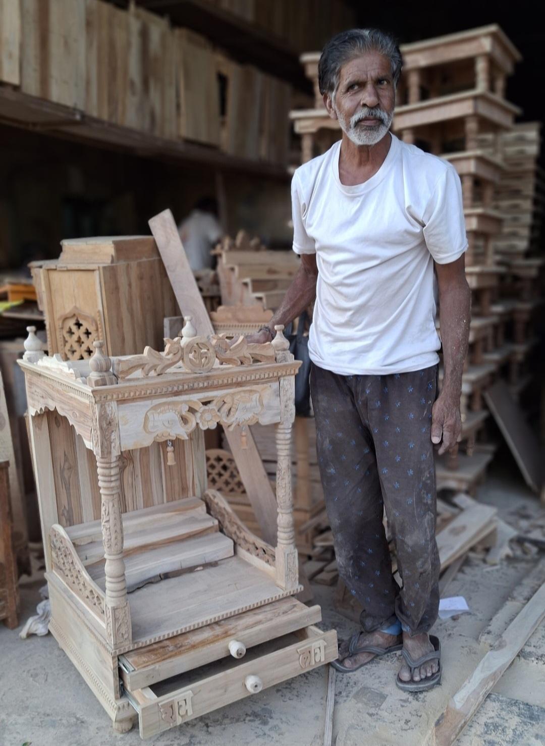 An artisan standing beside the devghar sculpted here. (Source: CKA Archives)