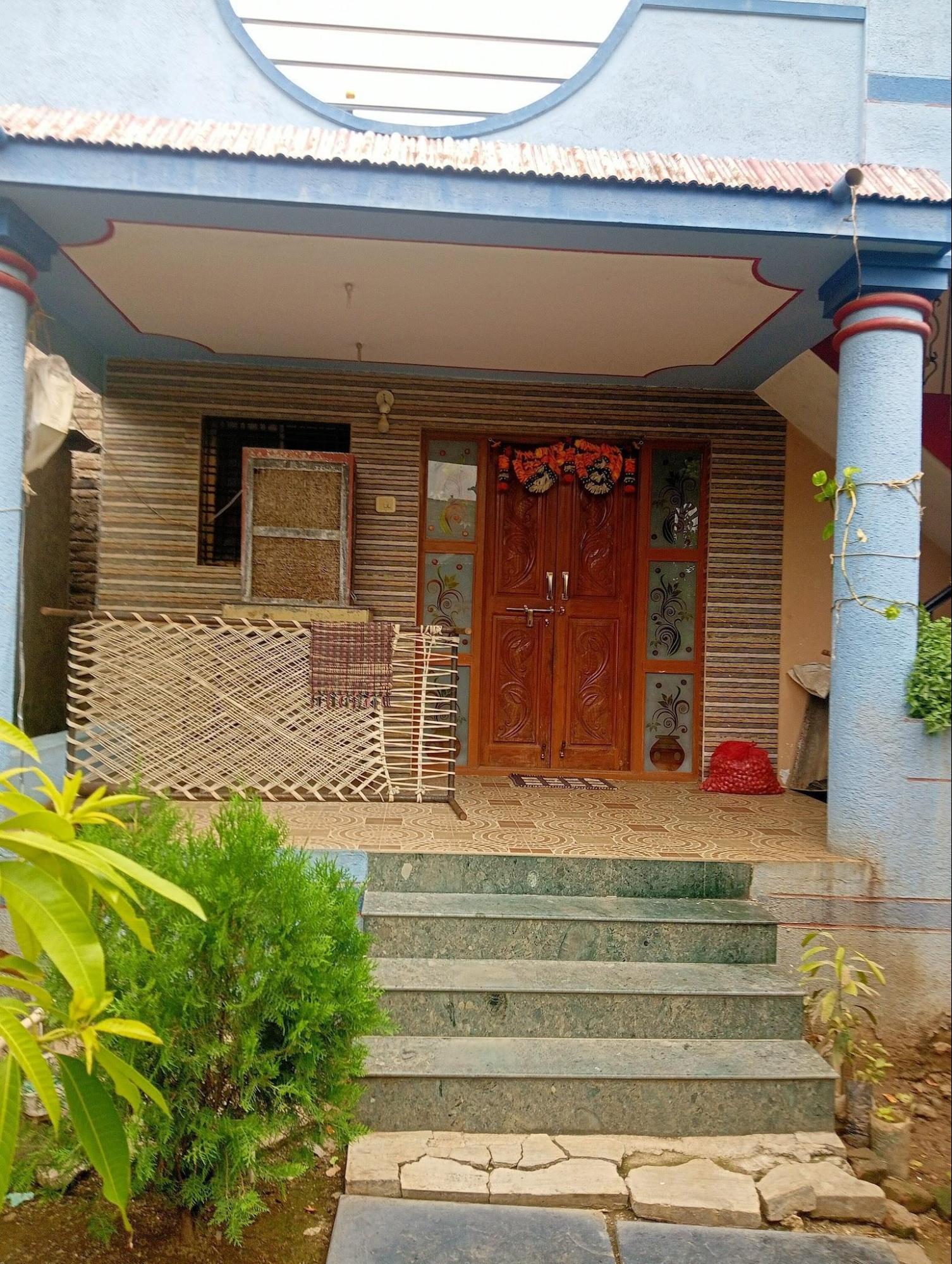 Front view of the house. The front door is decorated with beautiful embellishments. (Source: CKA Archives)