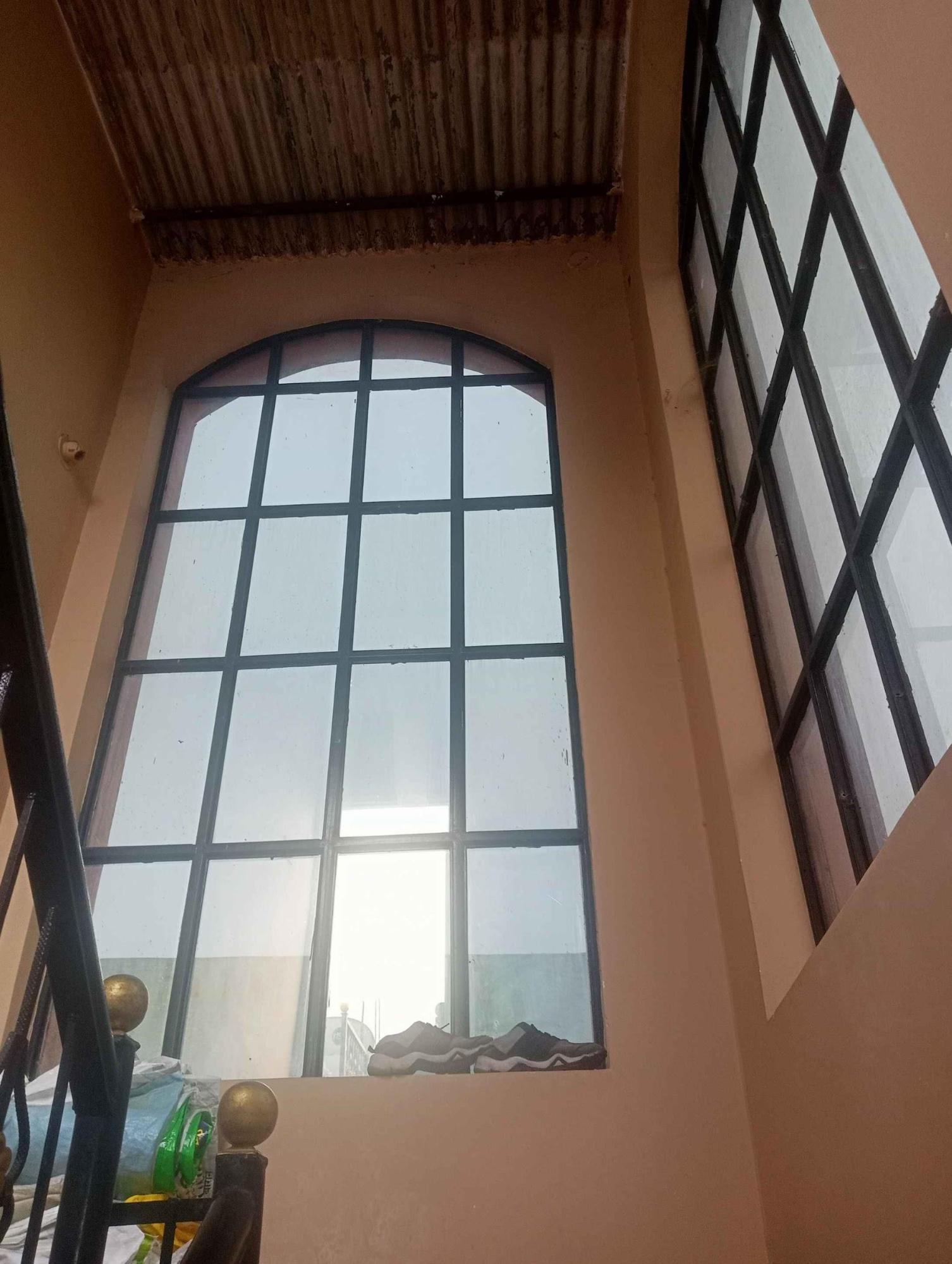 Tall window near the staircase. Notice how the tall arched window illuminates the staircase. (Source: CKA Archives)