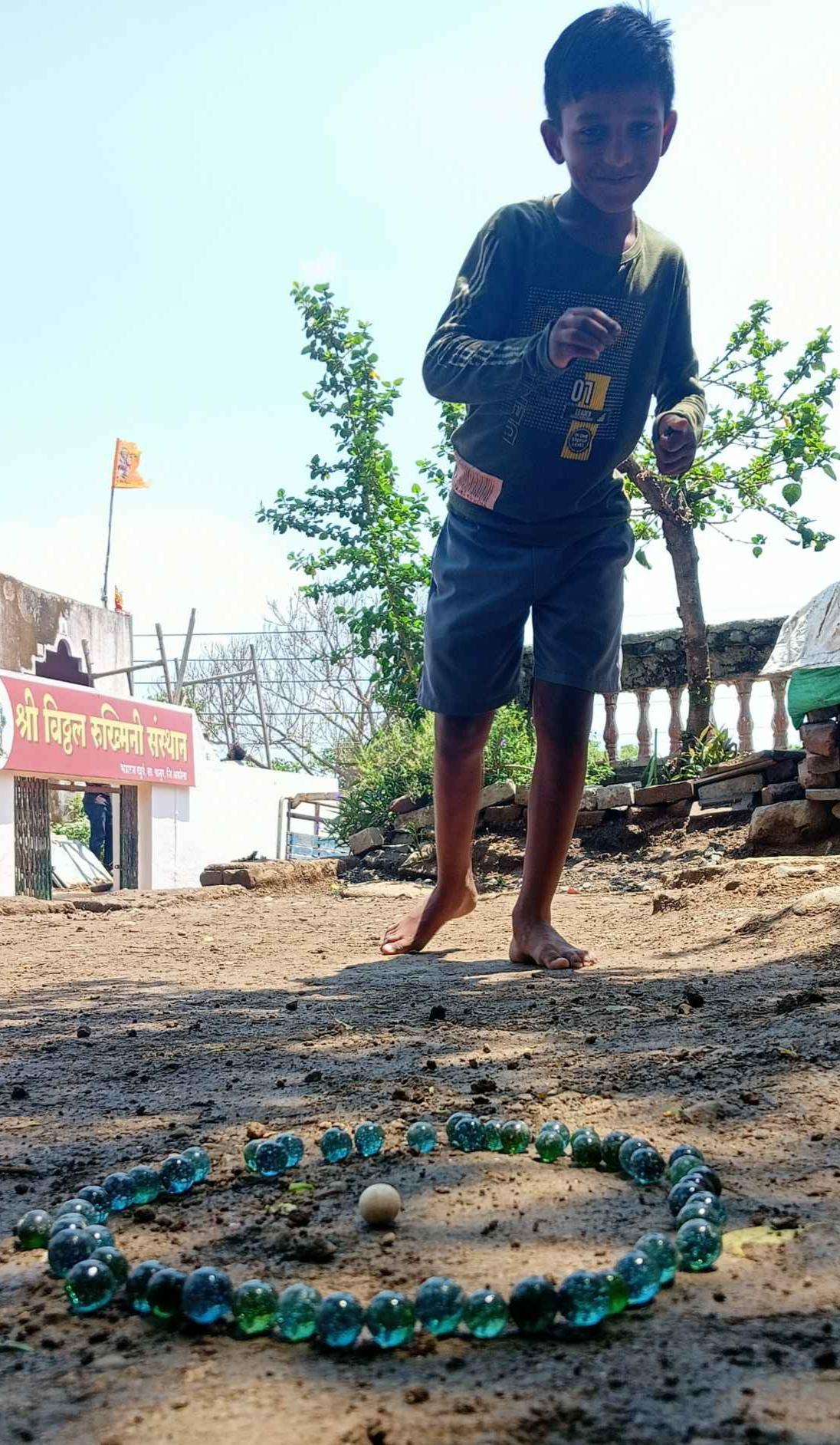 Kancha is a traditional game played with glass marbles, which are inexpensive and commonly available. For just one rupee, one can get 4 marbles (Source: CKA Archives).