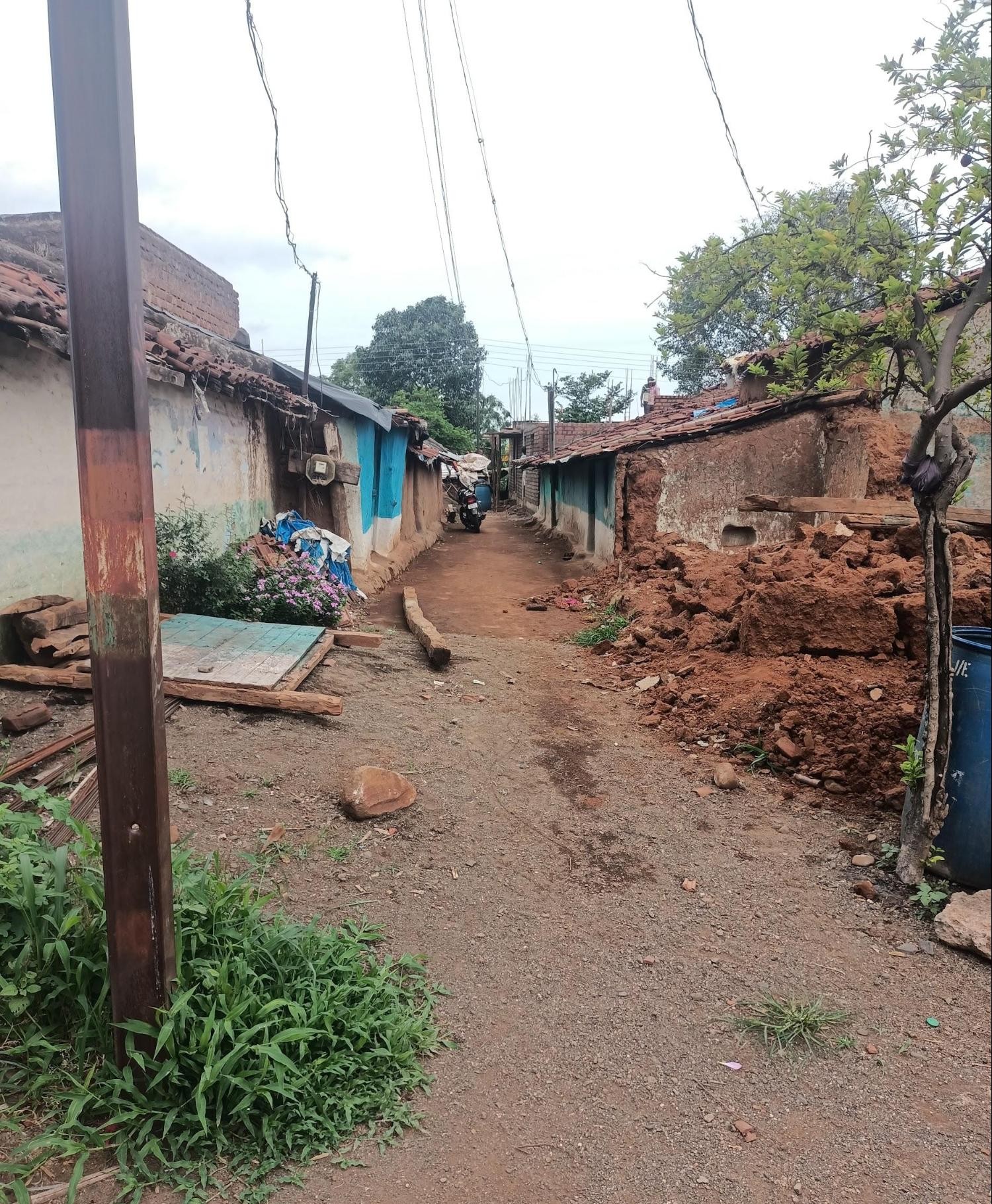 A narrower unpaved lane showing signs of recent construction or demolition work, with debris on one side. (Source: CKA Archives)