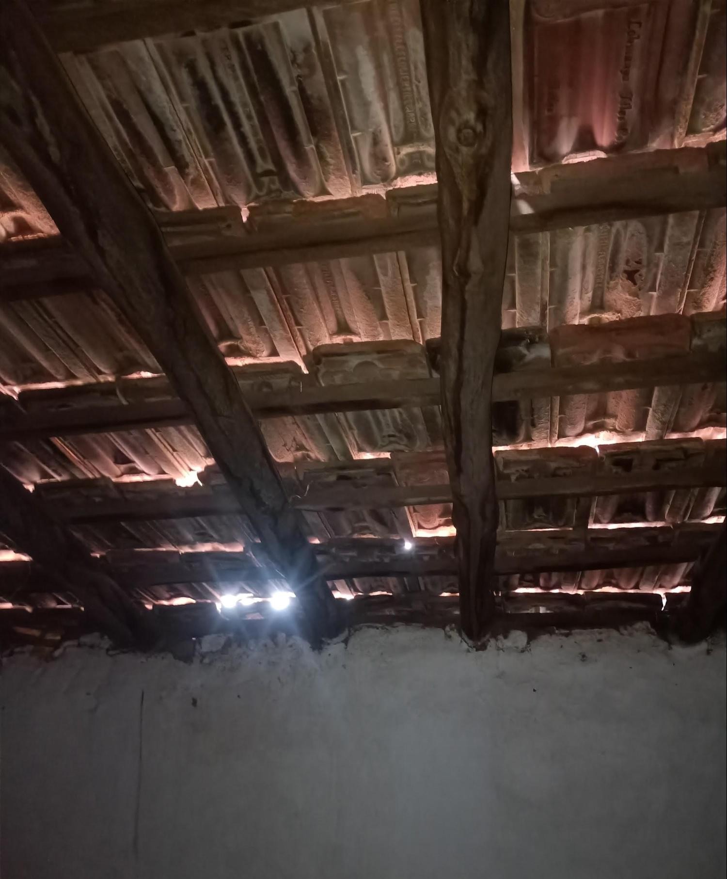 Interior view showing an exposed wooden rafter system with horizontal wooden purlins supporting the sheets above. (Source: CKA Archives)