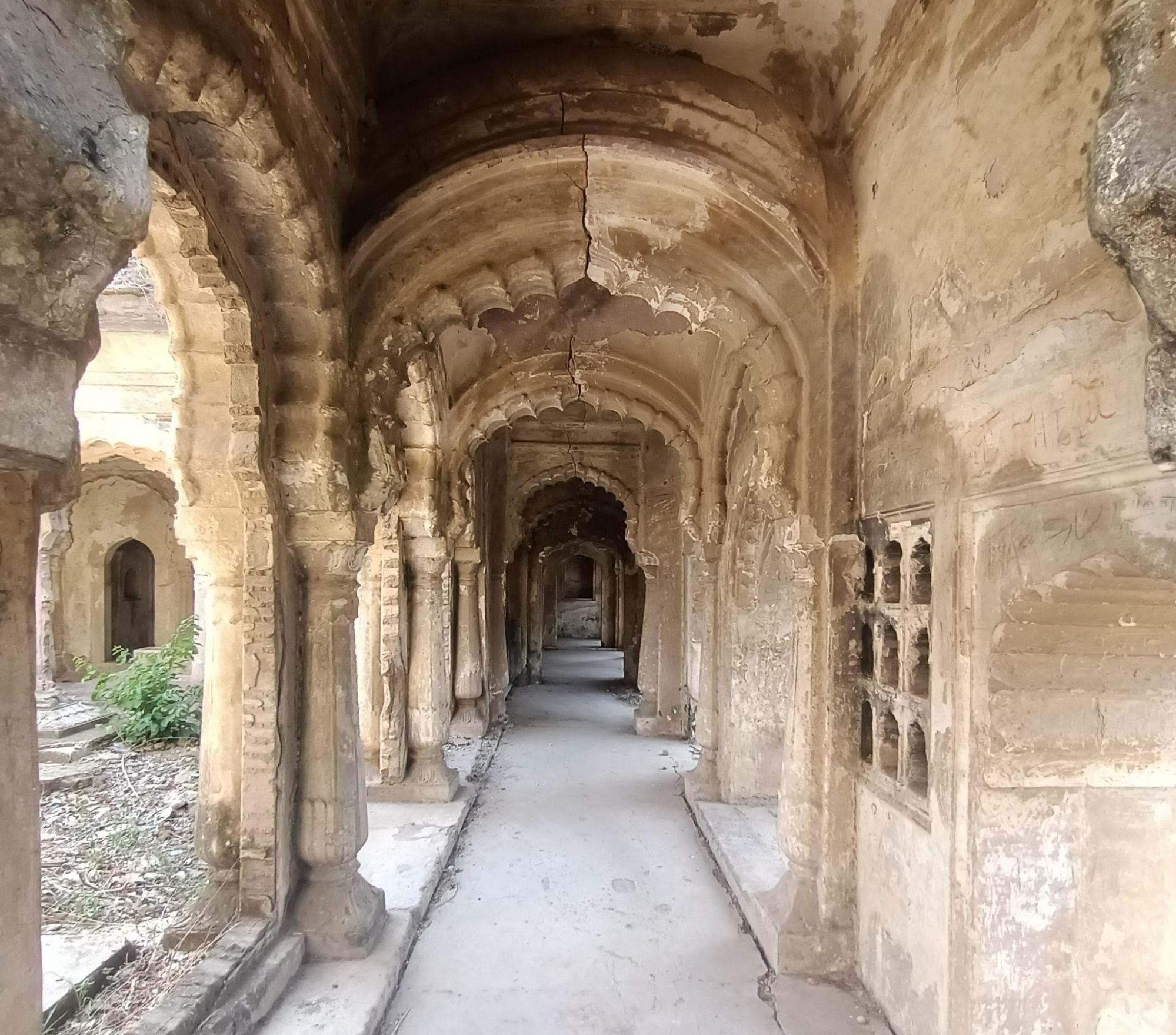 Long corridor at Bebah Bagh featuring repeated arched passages and stone latticework, illustrating the site’s architectural detail. (Source: CKA Archives)