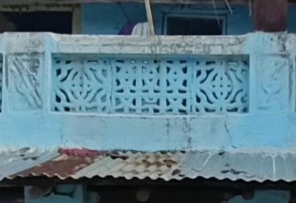 Parapet wall with geometric jaali patterns, painted in light blue, showing continuous decorative treatment along the building edge. (Source: CKA Archives)