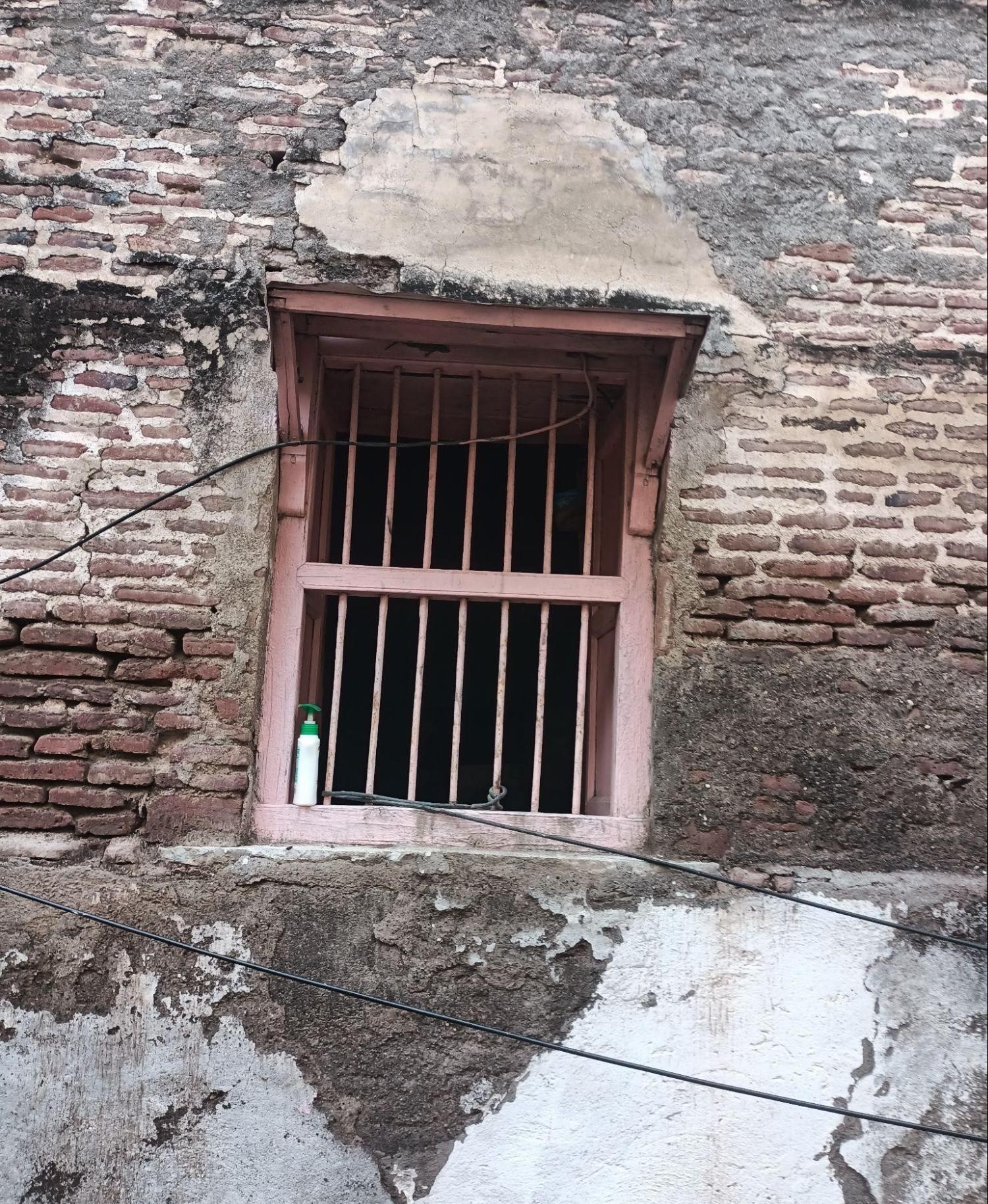 The window reveals an unadorned brick exterior, offering a glimpse into the masonry of the structure. (Source: CKA Archives)