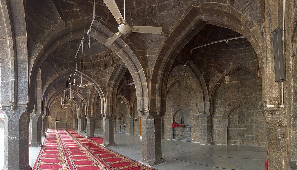 Interior of Jama Masjid, Beed, showing stone arches, domes, and intricate carvings preserved through restoration.[5]
