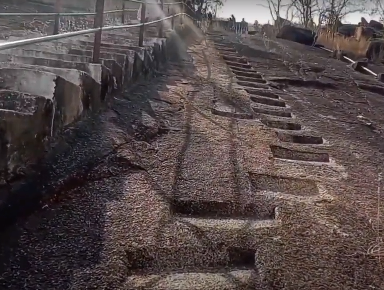 Older steps carved in stone are on the right, and newer concrete steps are on the left (Source: CKA Archives)