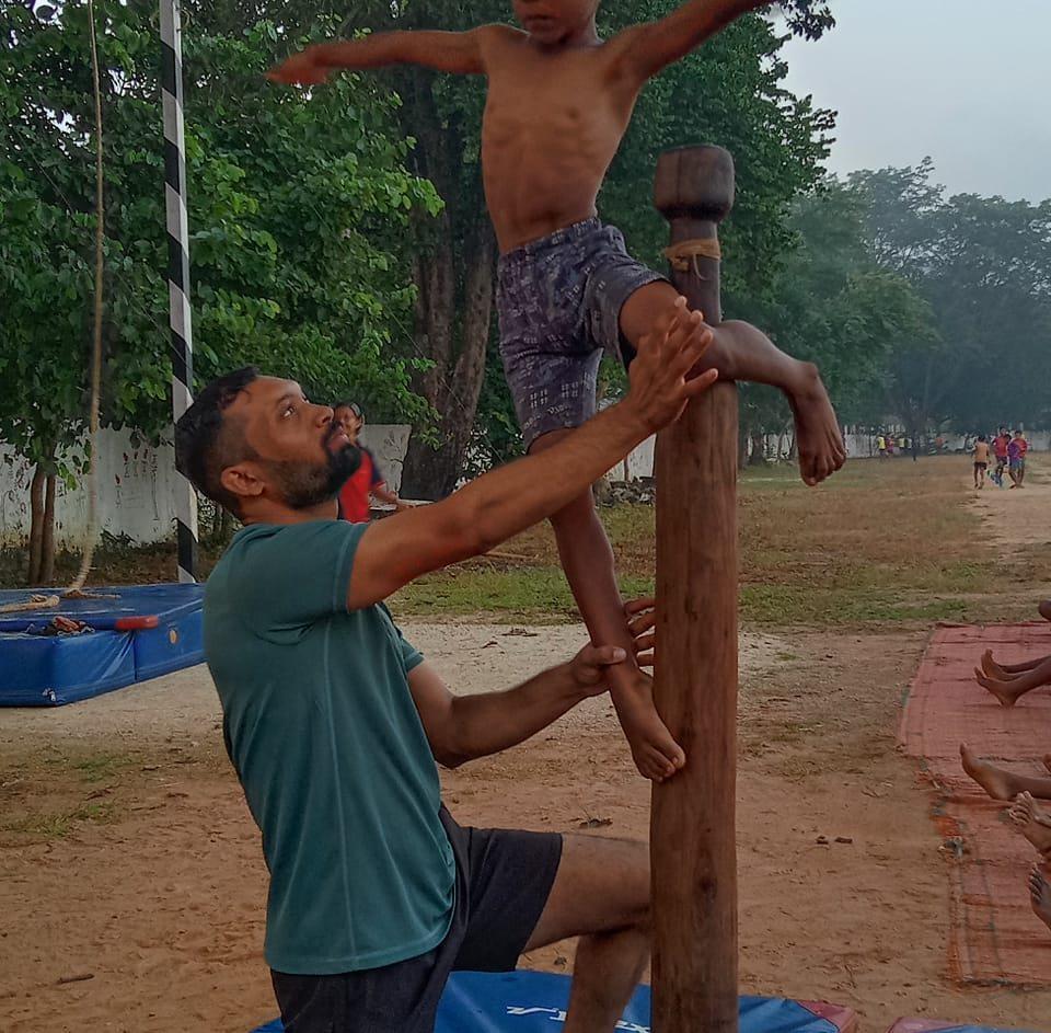 A coach training students in the art of Mallakhamb (Source: CKA Archives).