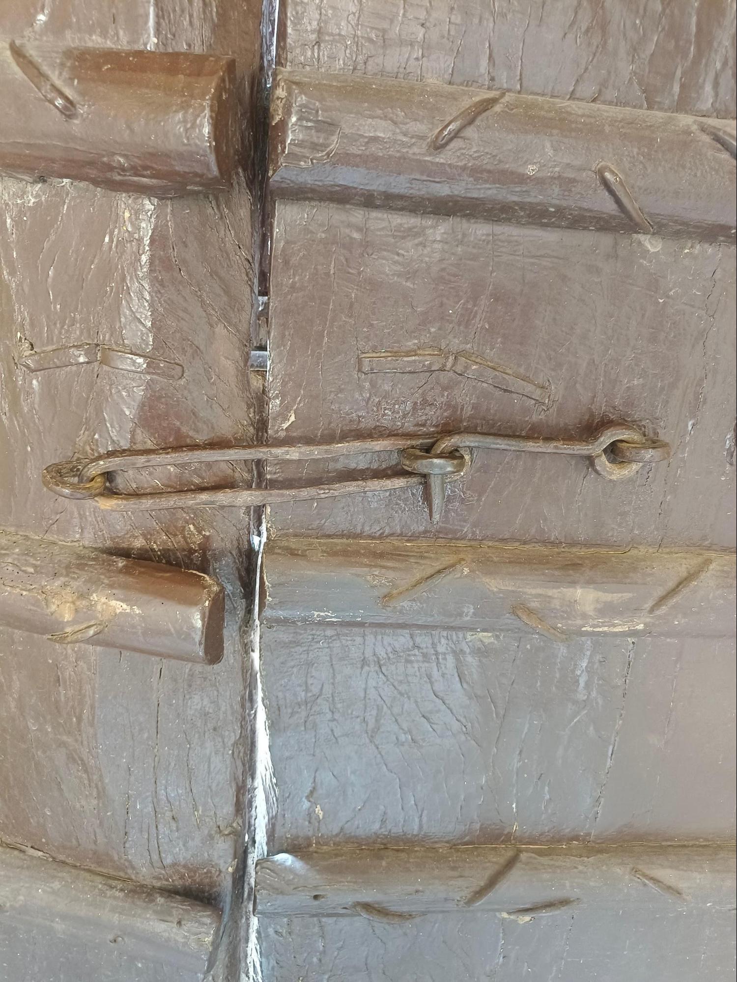 Close-up of the locking system, featuring a chain and padlock, commonly used in traditional wooden doors of Wada architecture. (Source: CKA Archives)