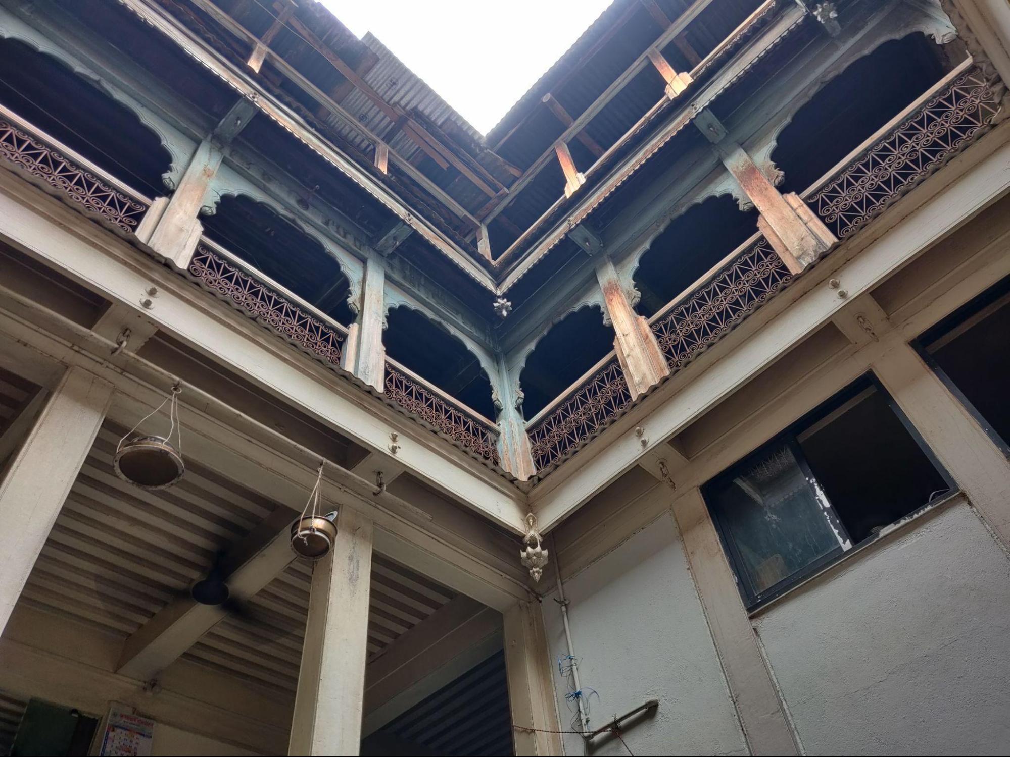 Another angle of the courtyard reveals the spatial relationship between different levels and the integration of light and ventilation in the design. Notice the wooden structural elements that support the upper floors. (Source: CKA Archives)