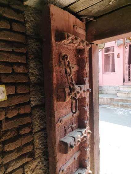 Close-up view of the ornately carved wooden entrance door with decorative columns on either side. (Source: CKA Archives)