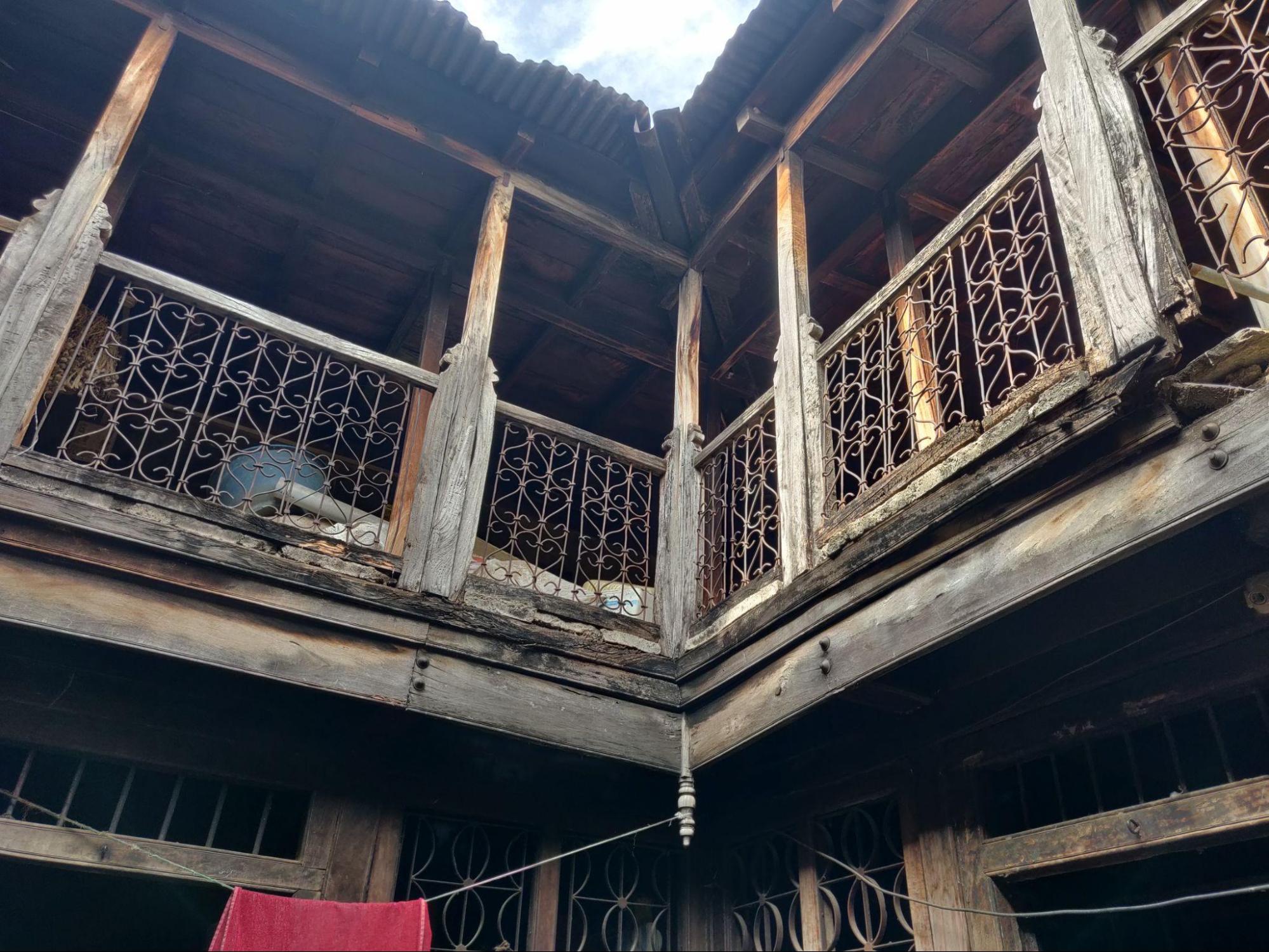 Decorative metal railings with a wooden top rail enclosing the upper storey. (Source: CKA Archives)