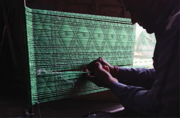 A weaver working on a Patola piece[5]