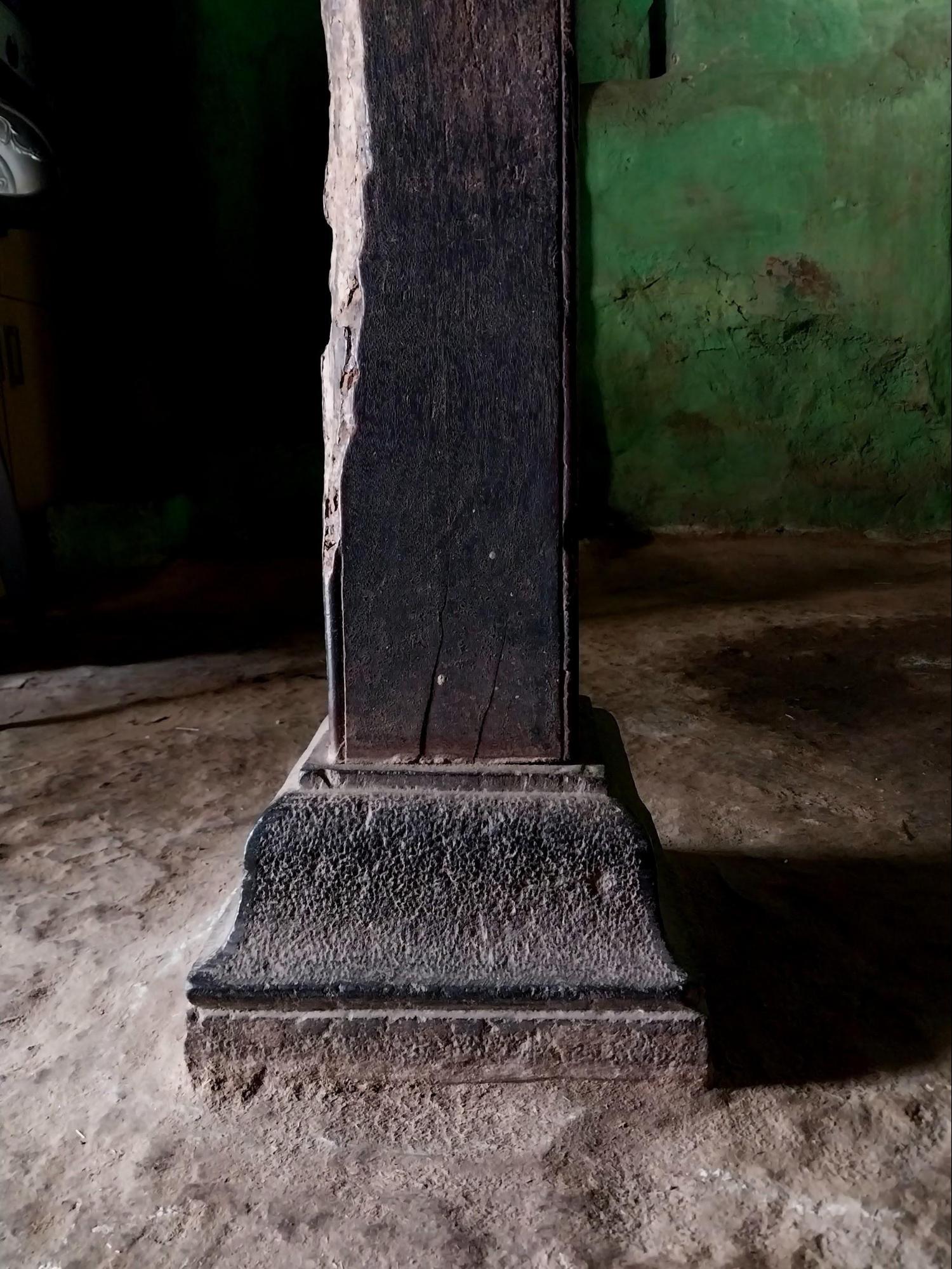 A close-up of a wooden column in the residence, set atop a stone base. (Source: CKA Archives)