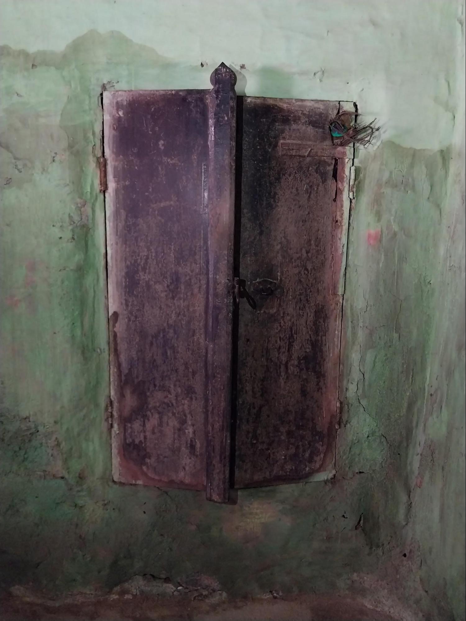 A wooden cupboard embedded directly into the wall structure, showcasing a built-in furniture design from a bygone era. (Source: CKA Archives)