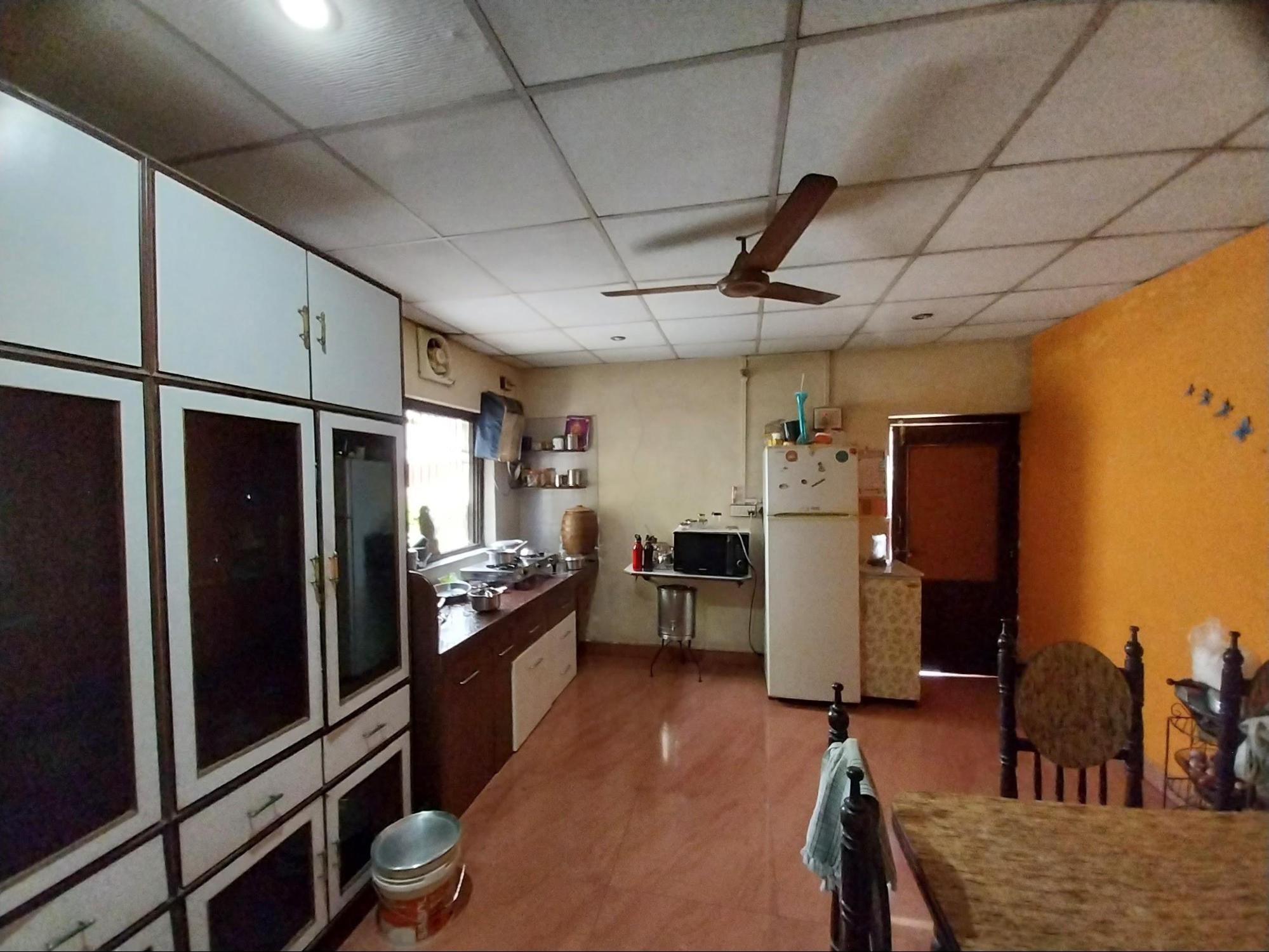 The recently renovated kitchen features contemporary modular design elements with no structural separation from the dining area. (Source: CKA Archives)
