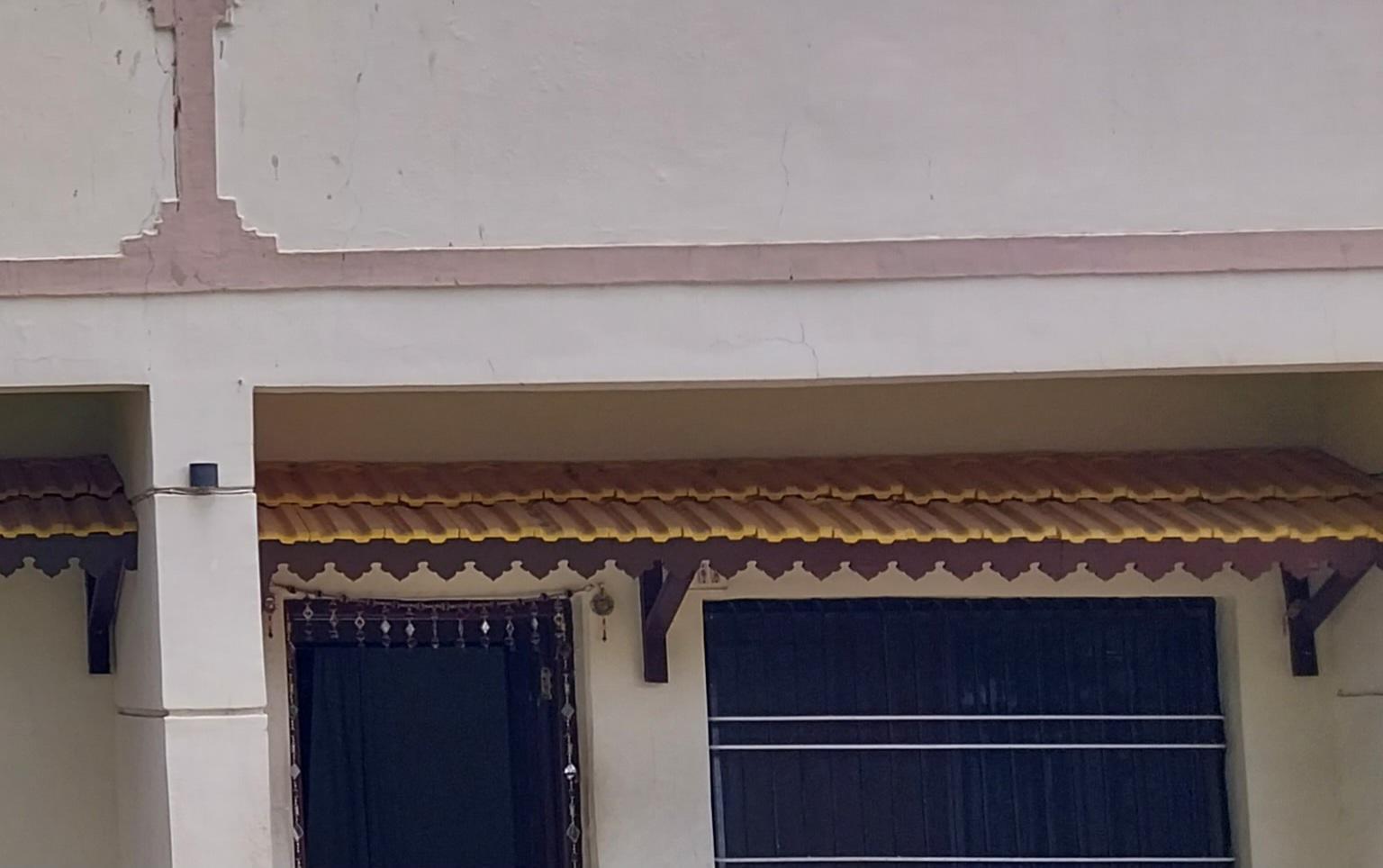 Window chajja (overhang) with distinctive roof-like design painted yellow and adorned with traditional motifs, illustrating the many decorative approaches that are tied to practical elements. (Source: CKA Archives)