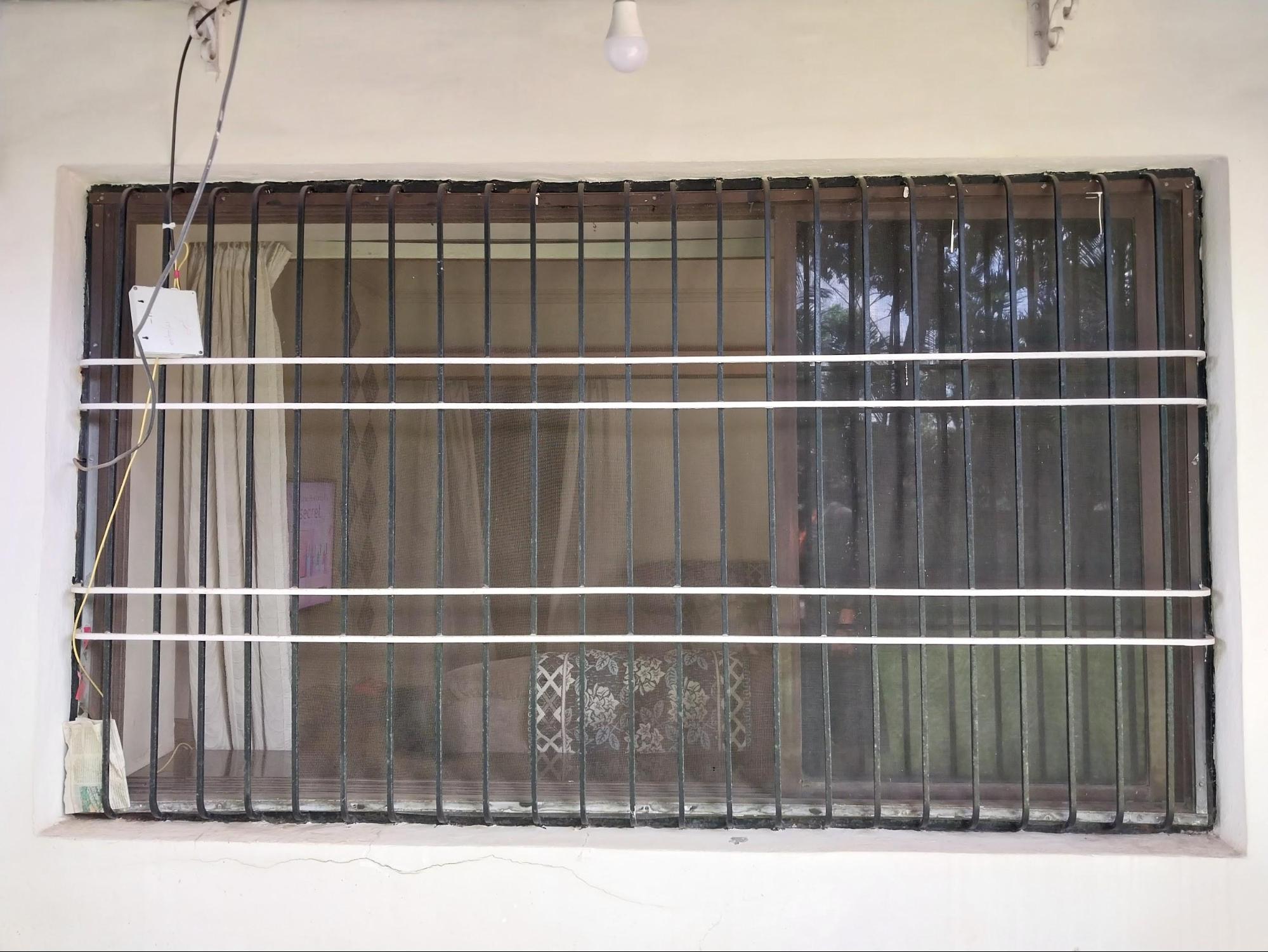 Windows on either side of the main entrance have modern protective railings while keeping the balanced design of the house front. (Source: CKA Archives)