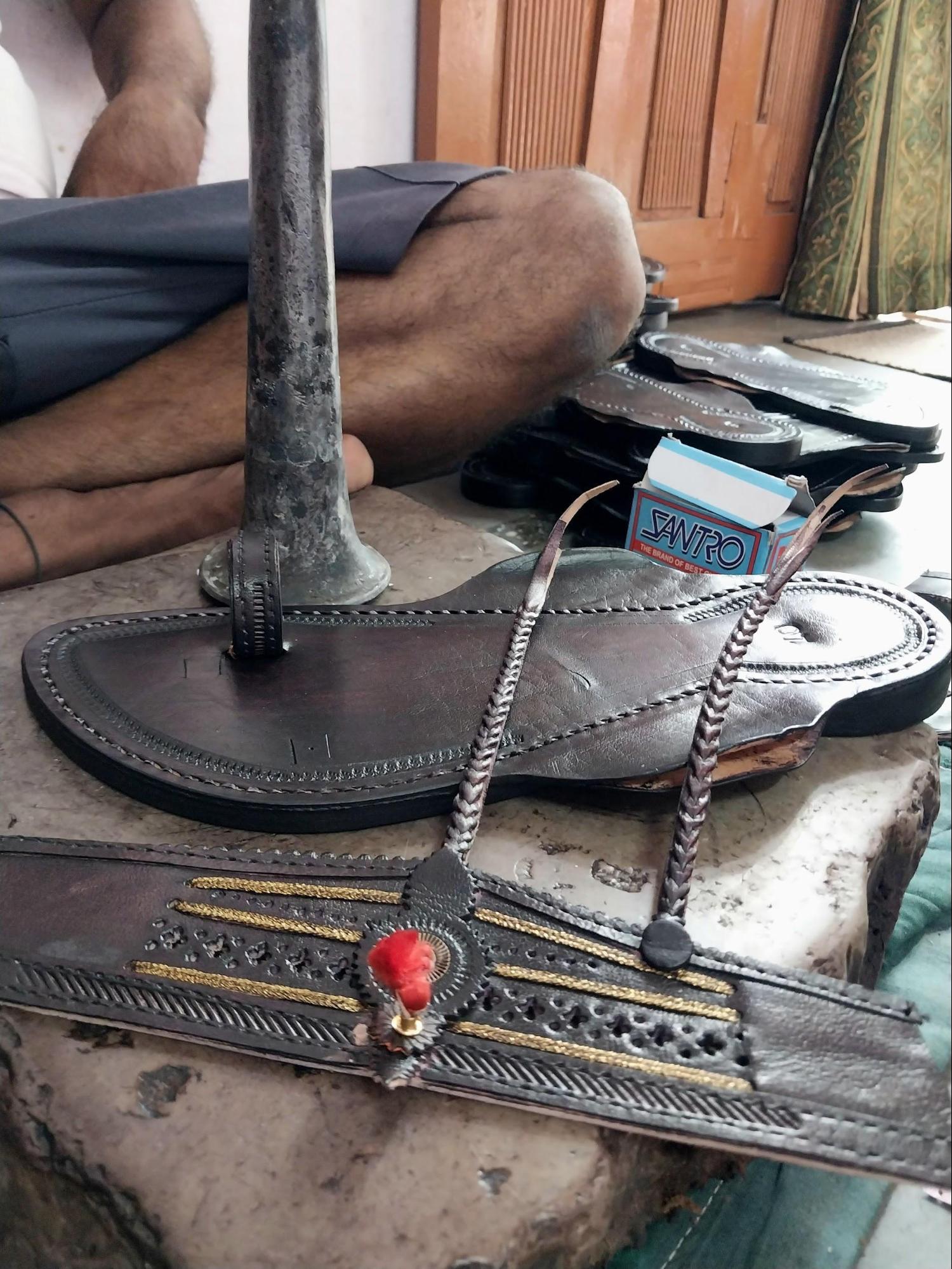 Larger straps featuring braided veni and gonda motifs are fixed onto the sole, completing the upper portion of the chappal. Source: CKA Archives