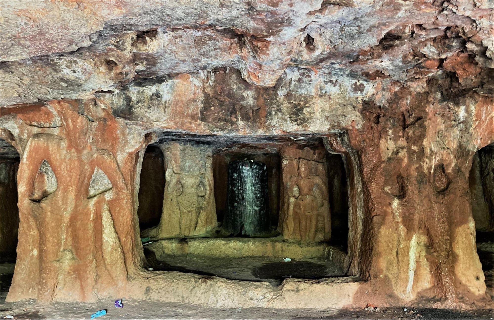 Interior corridor of a Kharosa cave with carved stone pillars. These pillars likely represent dwarpals (guardian figures) and lead to a shrine housing a Shivling. (Source: CKA Archives)