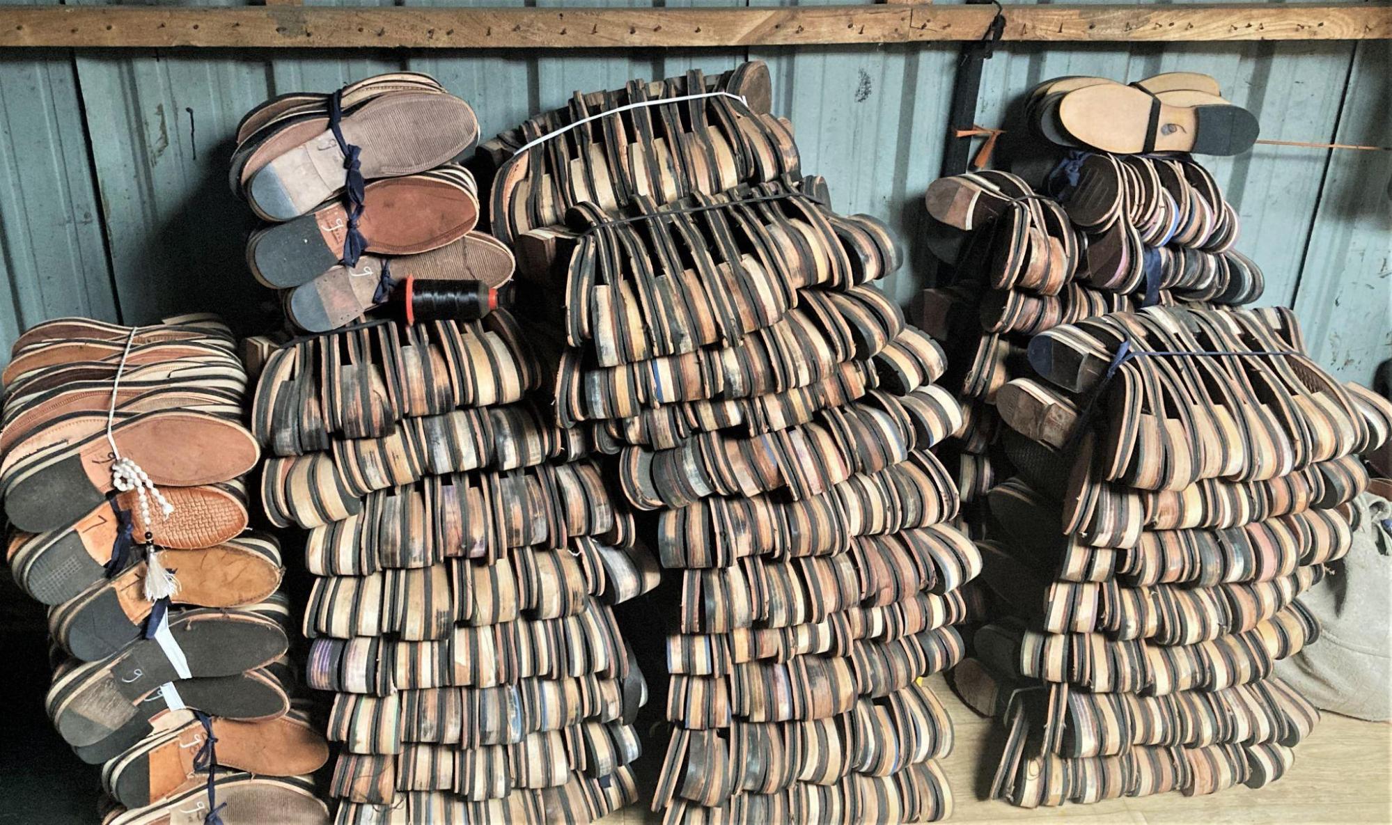 Chappal soles in various sizes and colors are stacked in a shop. (Source: CKA Archives)