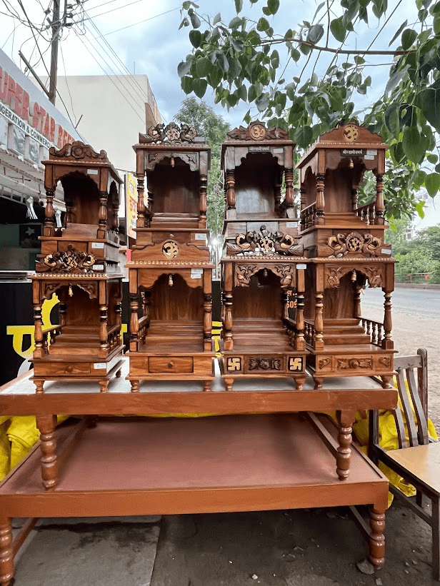 Wooden mandirs with detailed carvings and polished finishes on display. (Source: CKA Archives)