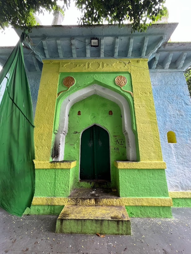 Ornately painted gateway of Masjid-e-Khwaja Basha in Udgir, featuring vivid green and yellow detailing, showcasing its unique architectural style. (Source: CKA Archives)