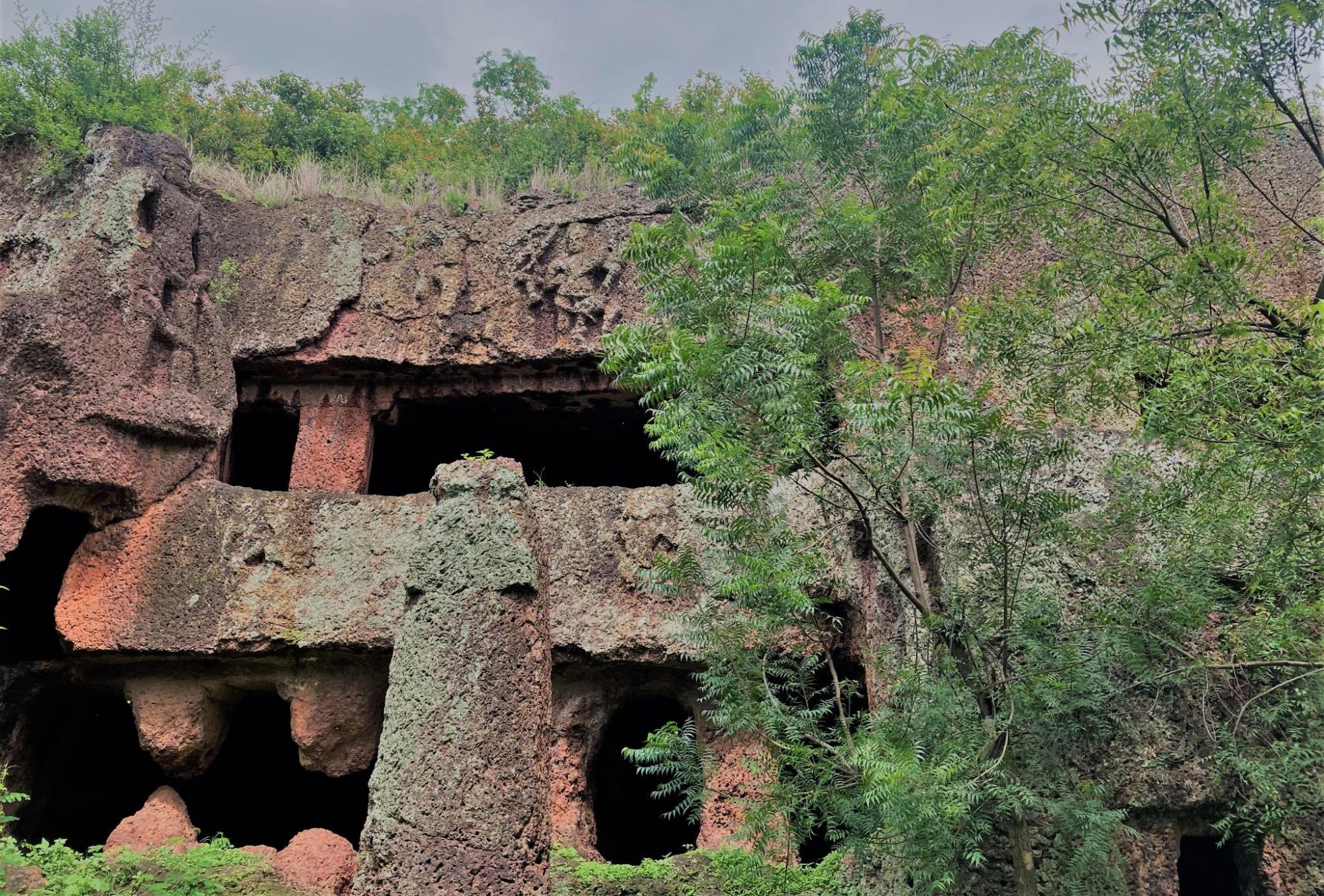 Exterior view of a rock-cut cave at Kharosa, Latur district, built during the Chalukya period (6th century CE). Visible on the facade is a carved figure of a yaksha, a guardian spirit commonly found in early Indian religious architecture. (Source: CKA Archives)