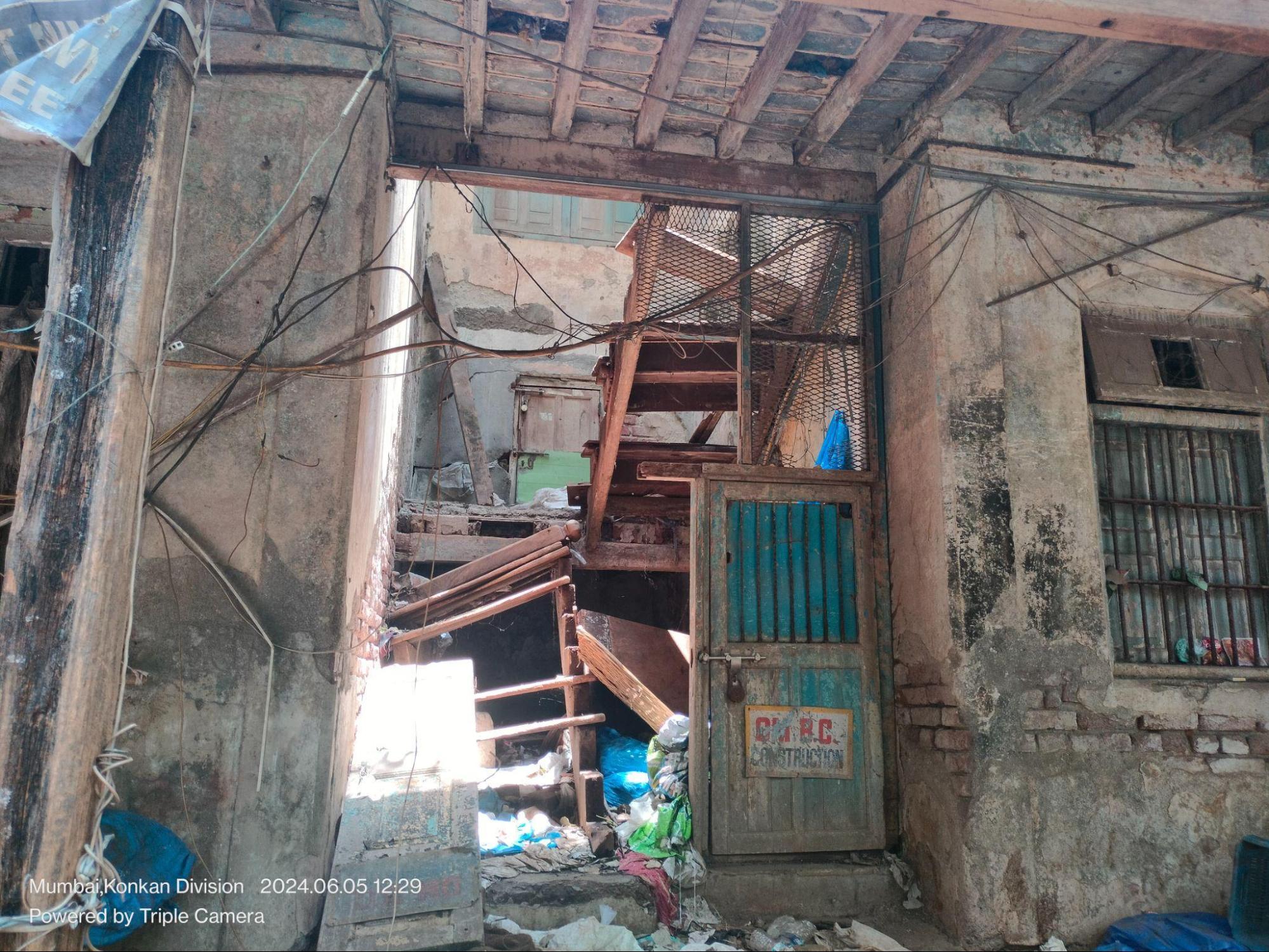 View of the wooden staircase that connects both floors; exposed beam structure supports the upper level.(Source: CKA Archives)