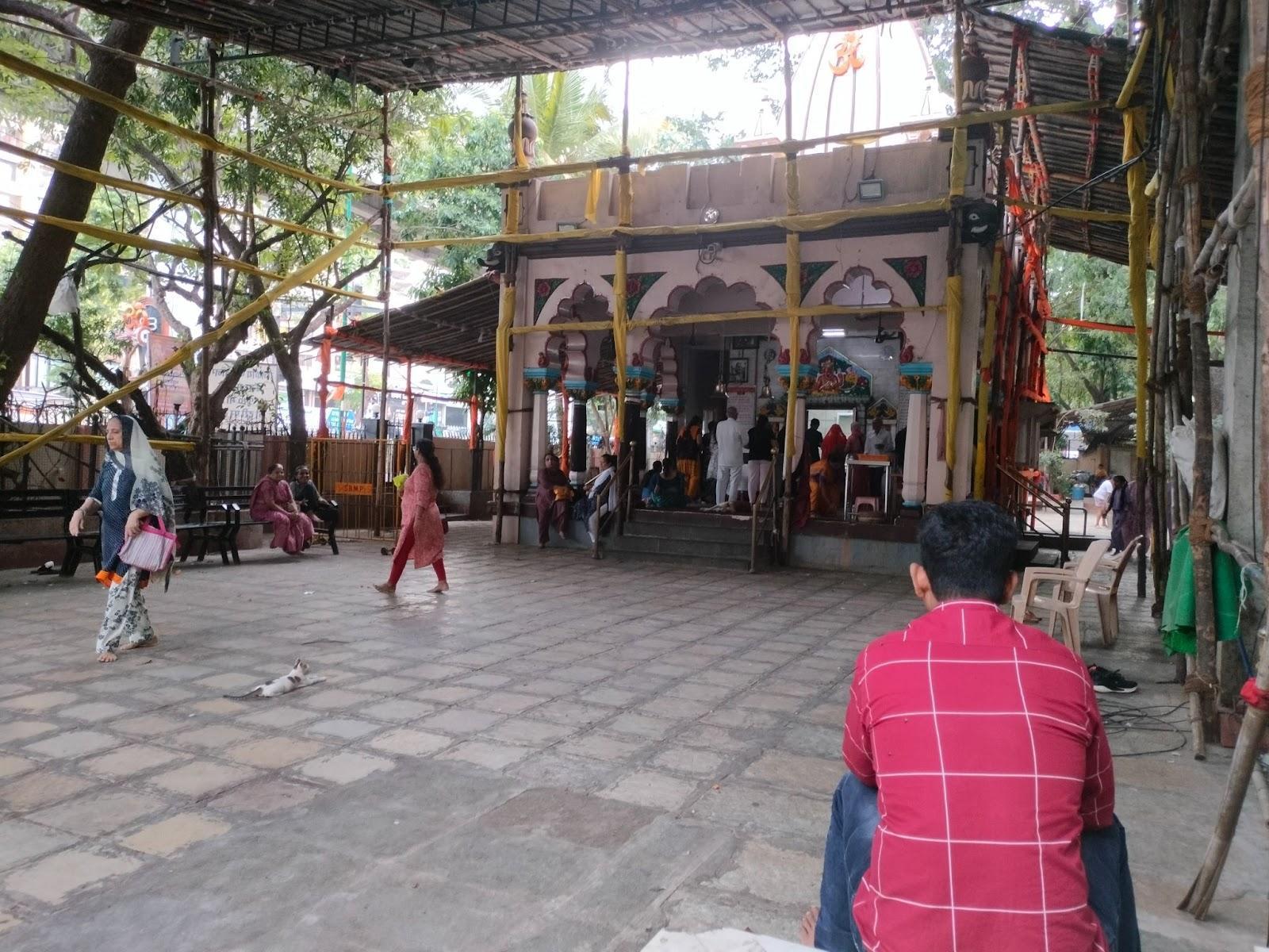 The Mandir courtyard is being decorated before a festival, with visitors gathered around the central structure for daily aarti. (Source: CKA Archives)