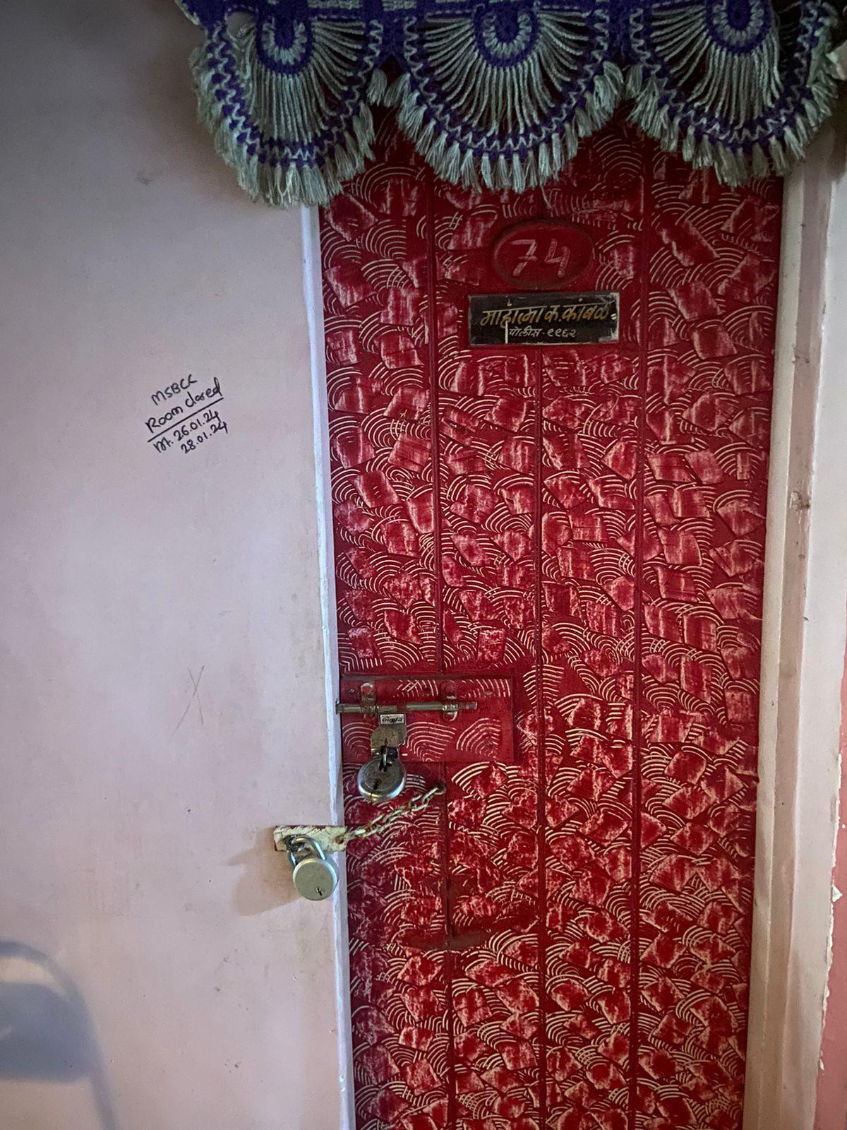 Apartment entrance with a bright colored PVC door and a decorative toran. Source: CKA Archives