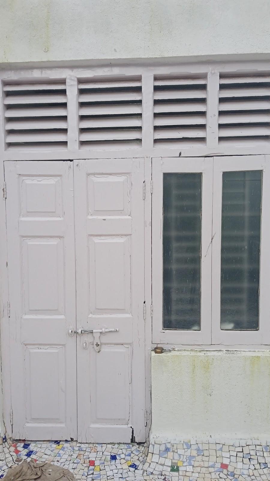 Double-panelled wooden door with a louvered opening above for ventilation. Source: CKA Archives