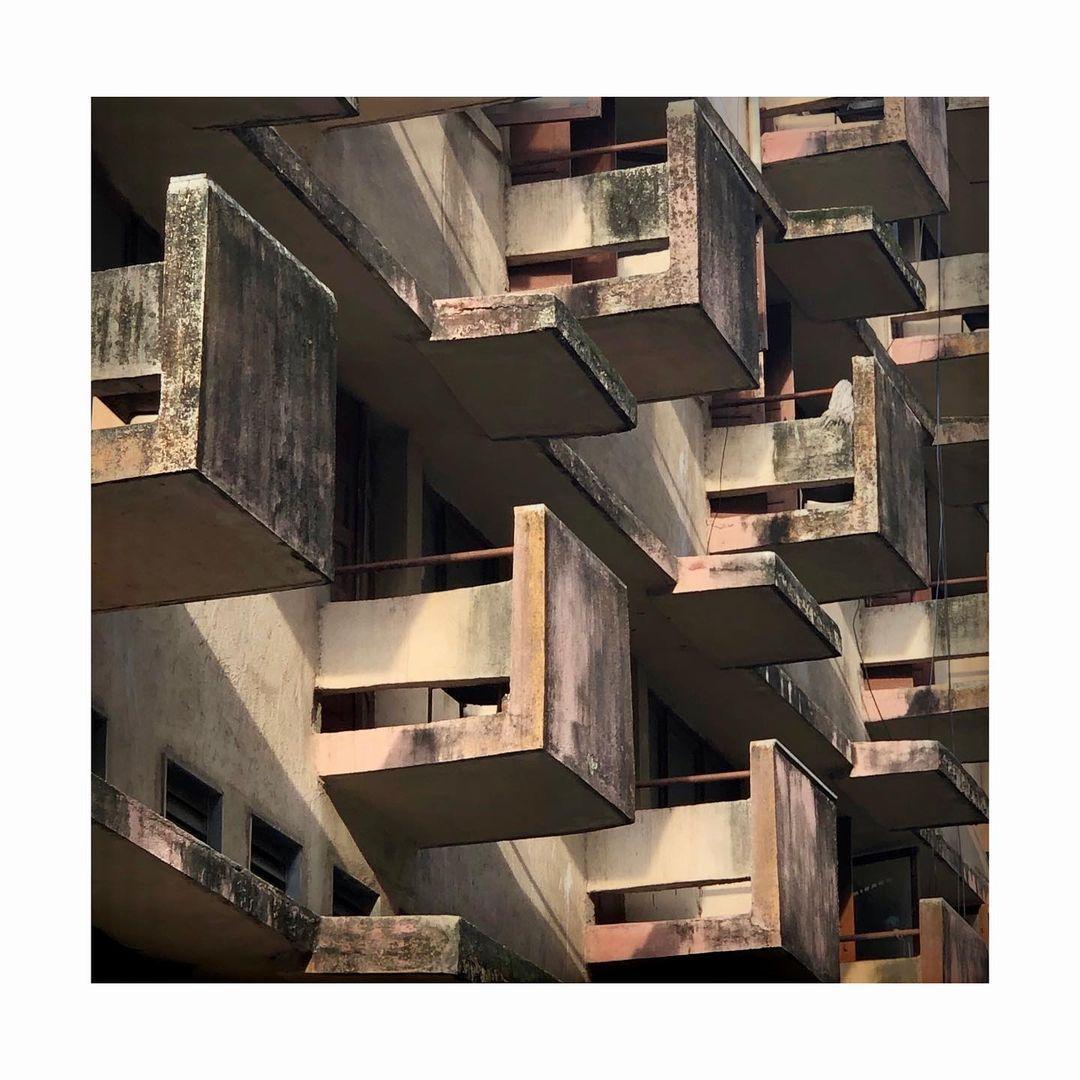 Modular balconies attached to each room in the hostel in a brick-red color. Source: CKA Archives