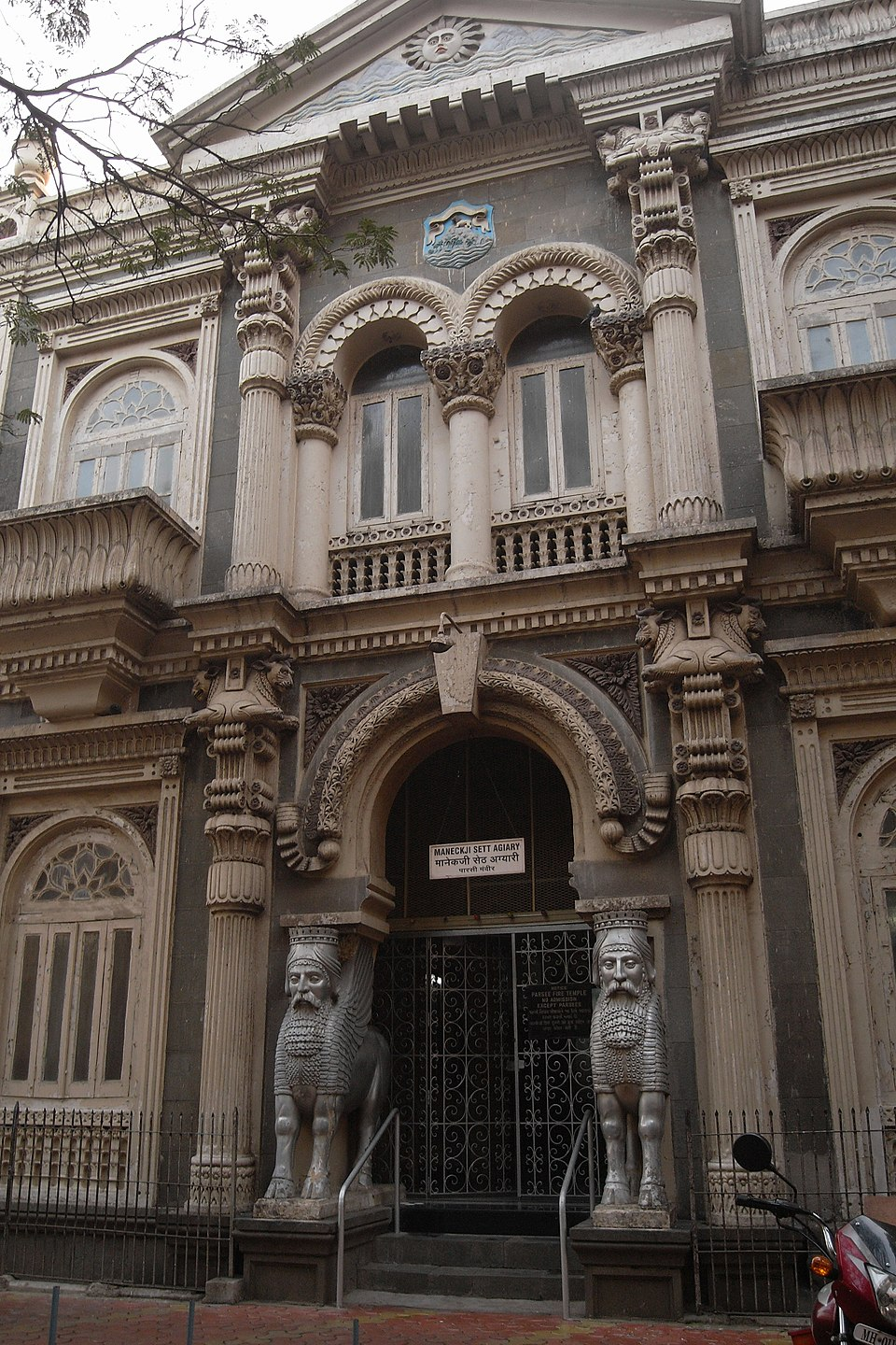 Persian-style columns with ram capitals and Grecian wreaths frame the entrance of Maneckji Seth Agyari, blending Greek Revival and Persian architectural styles.[4]