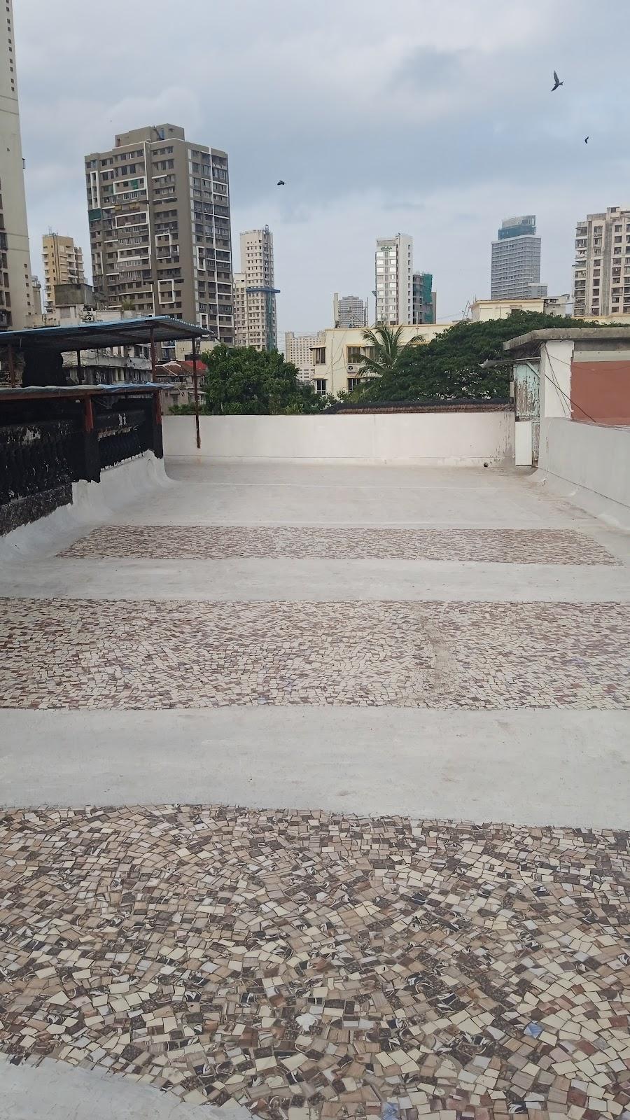 Terrace with an alternative pattern of china mosaic tiles and raw cement finish. Source: CKA Archives