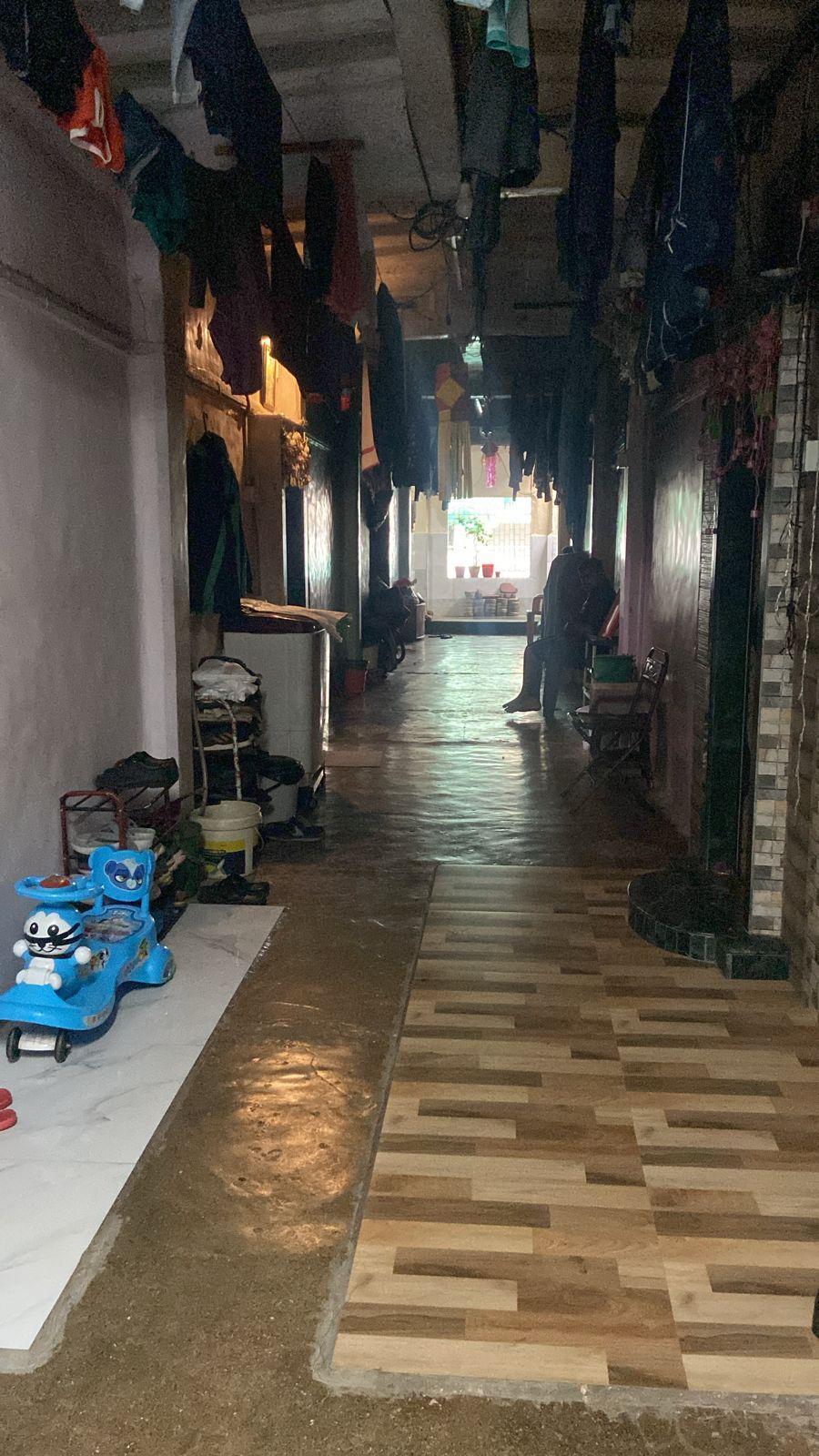 Tiled passageway connecting to individual units and serving as a common area. Source: CKA Archives