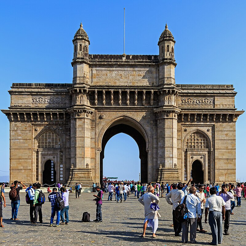The Gateway of India viewed from the Arabian Sea, standing as Mumbai’s most iconic colonial-era monument. Notice the commemorative inscription on the inner façade that marks its establishment for the 1911 visit of King George V and Queen Mary.[9]