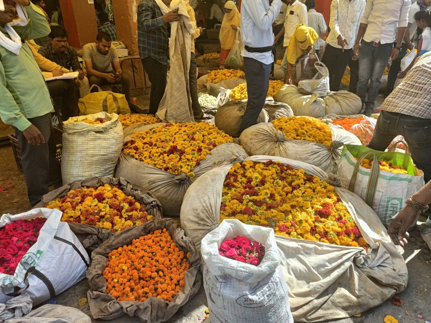 Sacks filled with marigolds and roses ready for sale at Nagpur’s Phule Market, a key flower trading hub.[3]