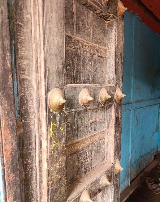 The main entrance door of the residence is adorned with delicate wooden work and iron spikes for protection. (Source: CKA Archives)