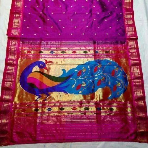 A traditional Paithani saree featuring peacock motifs woven with gold zari on the pallu.[1]
