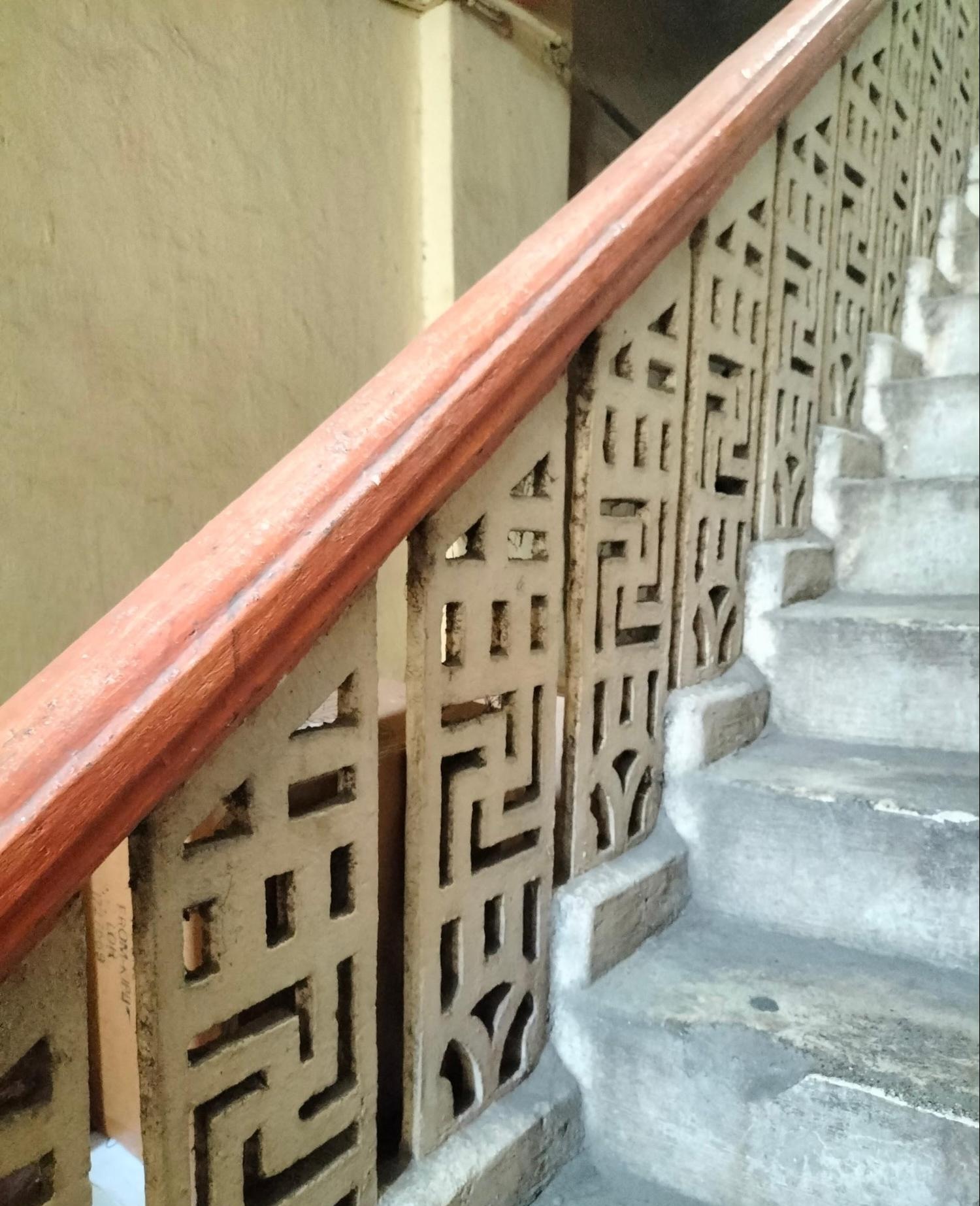 Internal railing along the staircase with a yellow swastika design, a symbol in Hinduism which is often associated with good fortune. (Source: CKA Archives)