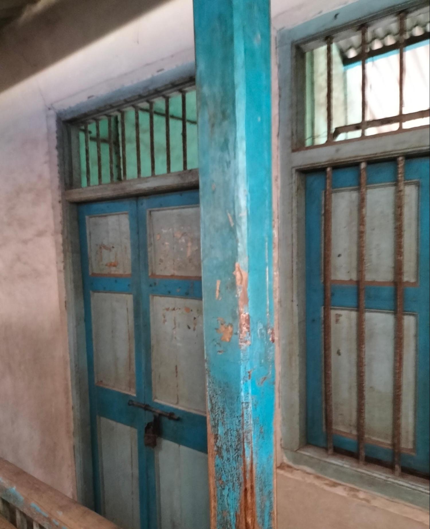 Wooden door with a grill for ventilation at the top. A window can also be seen to the right of the entrance door. This kind of a structural setup is common in residential quarters. (Source: CKA Archives)