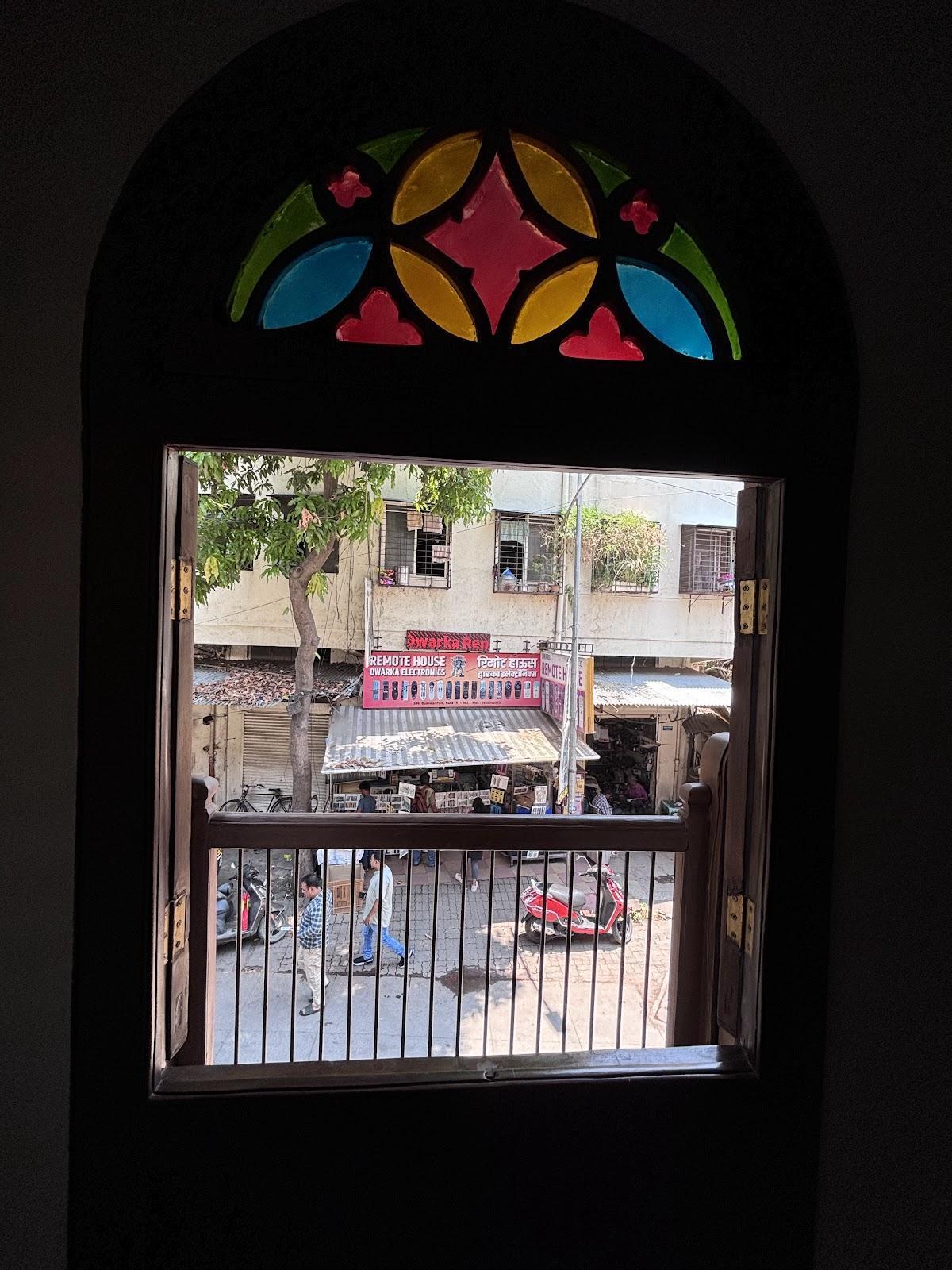 A three-piece window featuring a stained-glass top, a ventilated middle section, and a grilled bottom, with double-door shutters that open outward. (Source: CKA Archives)
