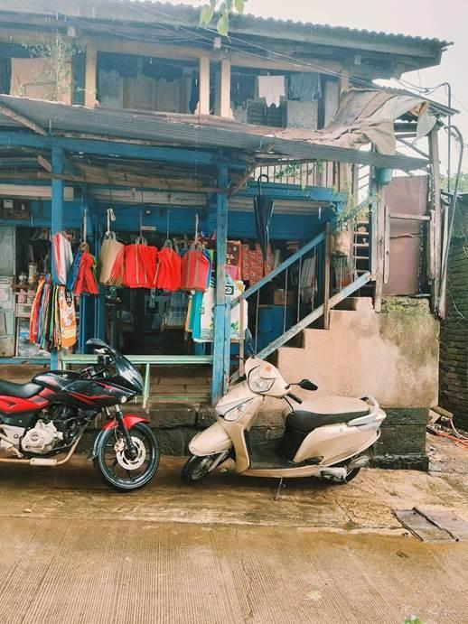 Railing with concrete steps and blue-colored wood and metal railings leading up to the private residences on the second storey. (Source: CKA Archives)