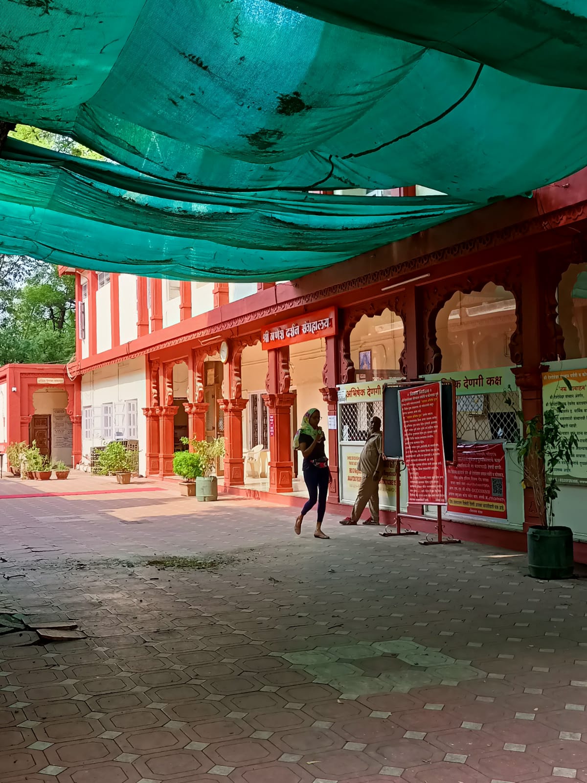 The museum, located behind the Mandir, painted in matching red and white with carved pillars, mirroring the main Mandir’s aesthetics. (Source: CKA Archives)