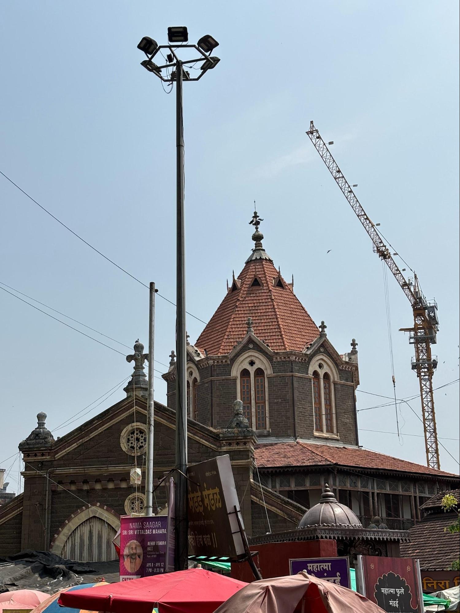 Gothic-inspired arches and wooden roofing inside Mahatma Phule Mandai, reflecting 19th-century British architectural influence. (Source: CKA Archives)