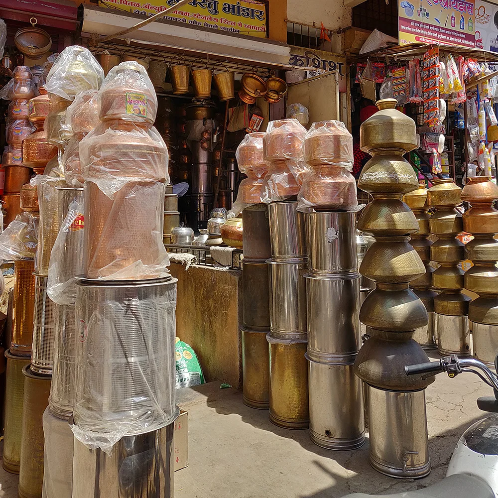 Rows of gleaming steel and ceramic kitchenware on display at Bhandi Ali, Pune’s historic utensil lane.[7]