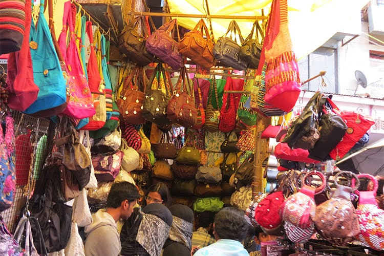 Shoppers crowd Laxmi Road’s busy storefronts, Pune’s iconic destination, for sarees, jewelry, and festive shopping.[3]